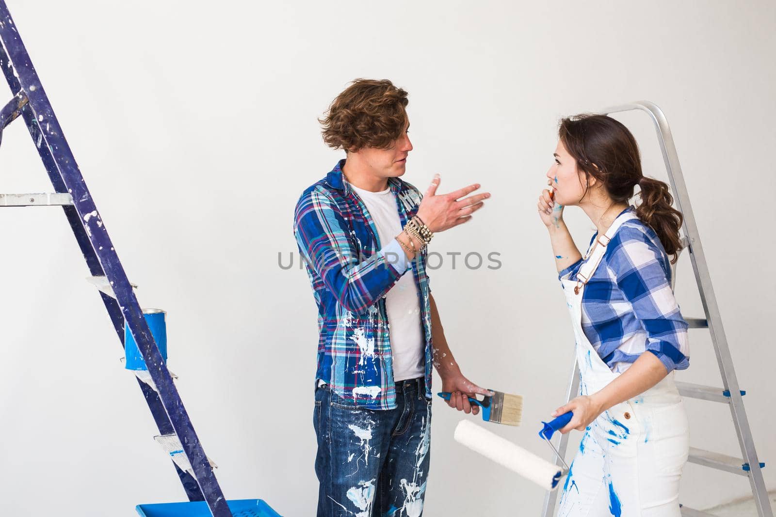 Conflict, repair, renovation and people concept - a couple doing a repair in apartment and argue.
