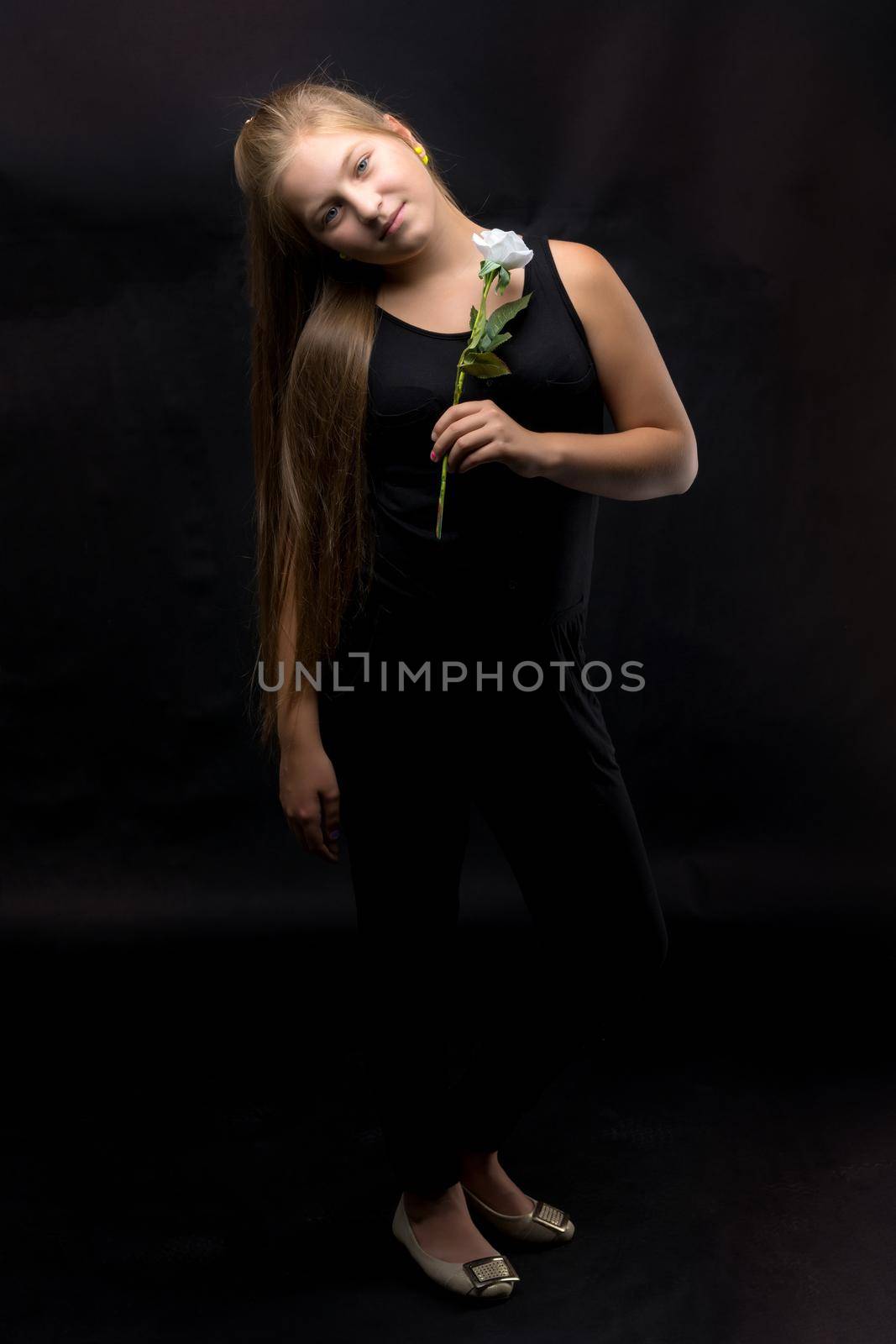 Teenage girl with a flower in her hand by kolesnikov_studio