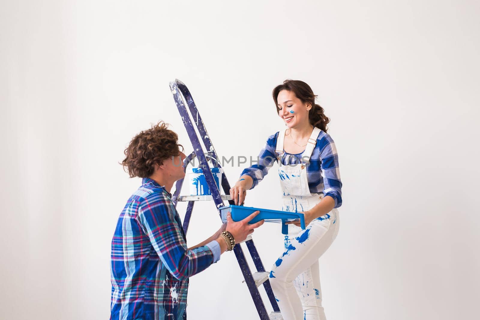 Teamwork, renovation and repair concept - Portrait of funny couple doing redecoration in apartment by Satura86