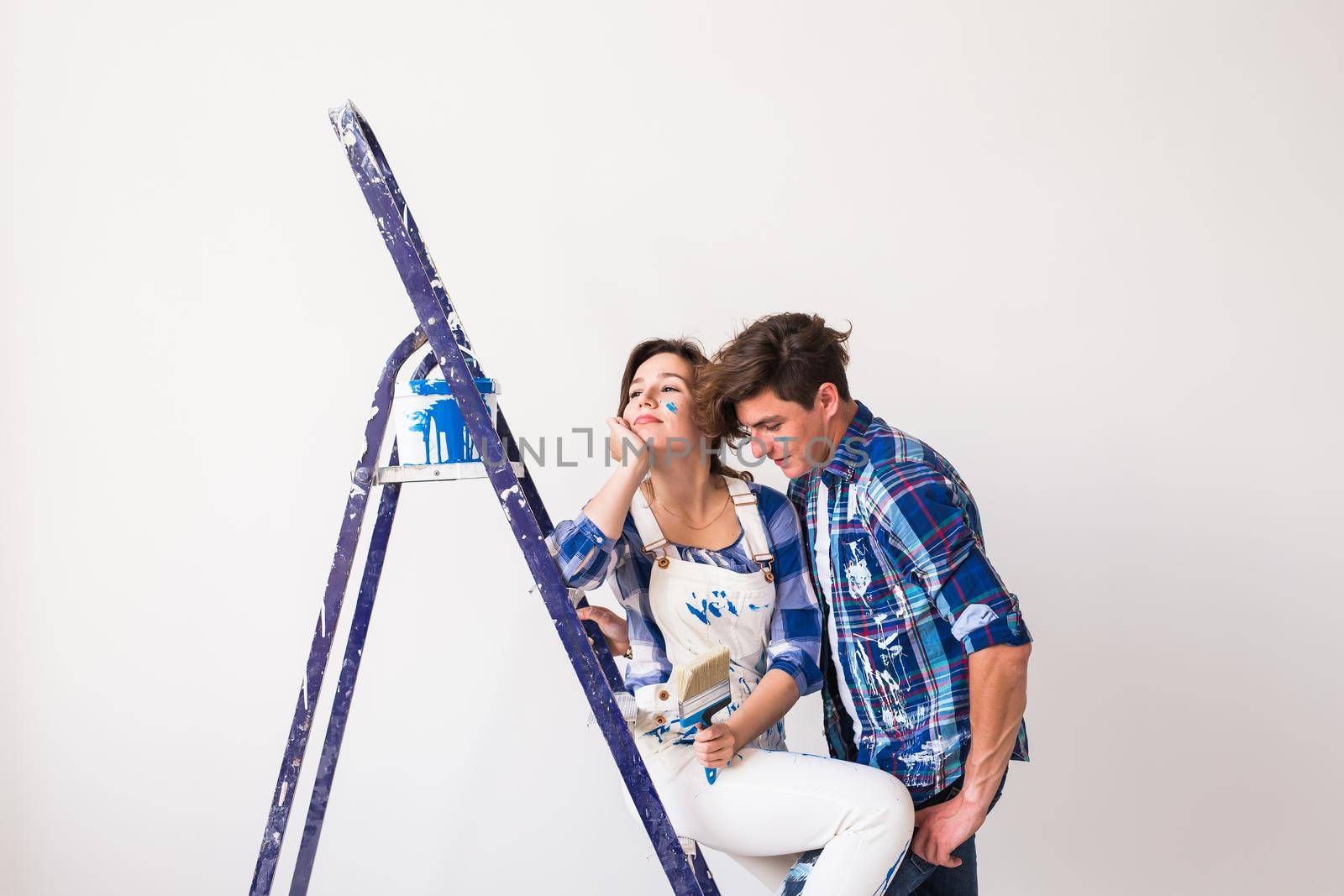 People, renovation and repair concept - Portrait of lovely couple doing redecoration in apartment.