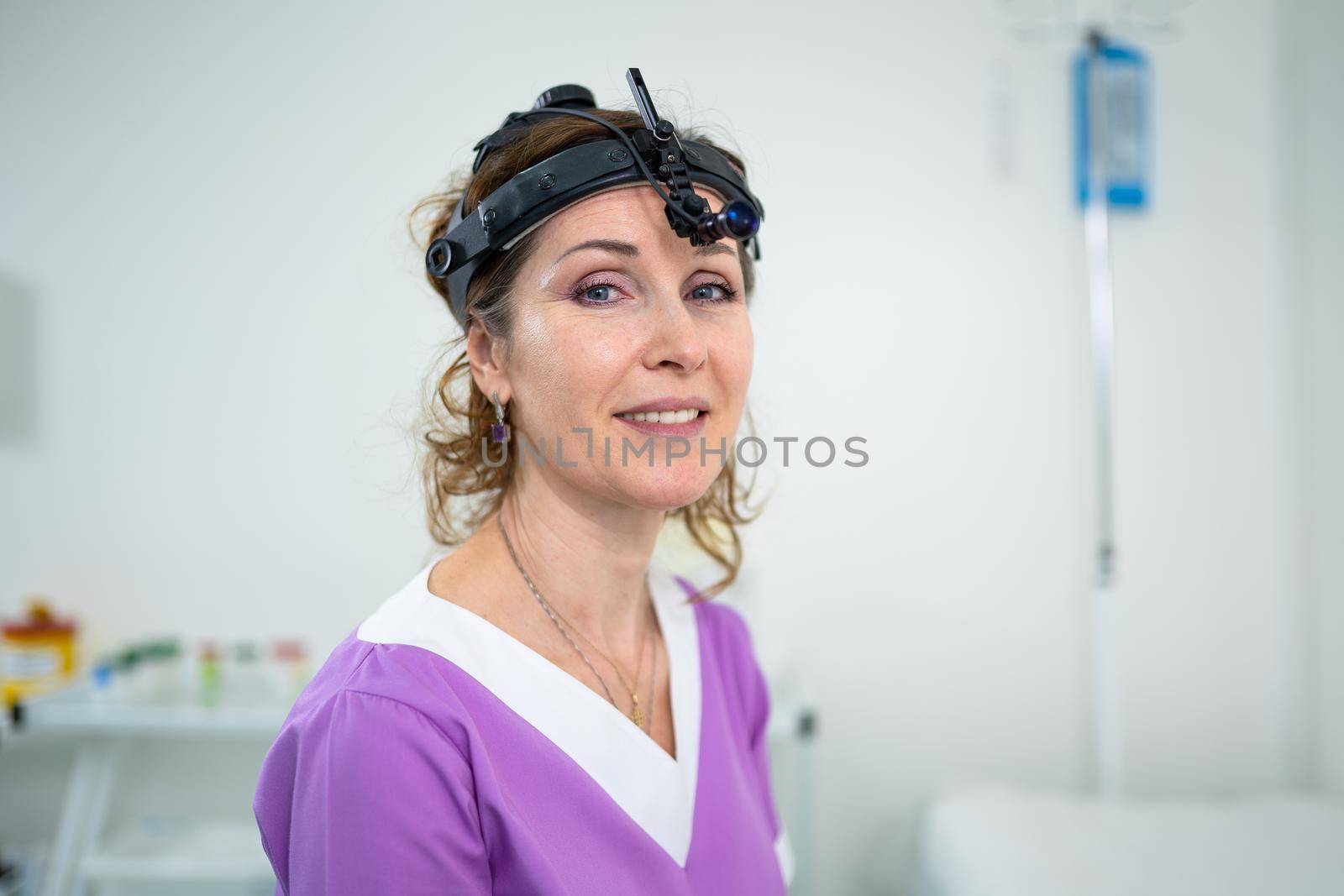 Professional otolaryngologist in modern clinic. Portrait of woman otolaryngologist or audiologist. Healthcare occupations. ENT doctor. Otolaryngology specialist posing in clinic by Tomashevska