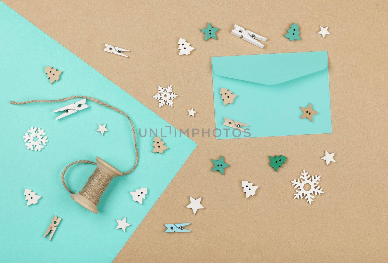 Close up packing and wrapping Christmas gifts with blue and brown paper, table top view, flat lay