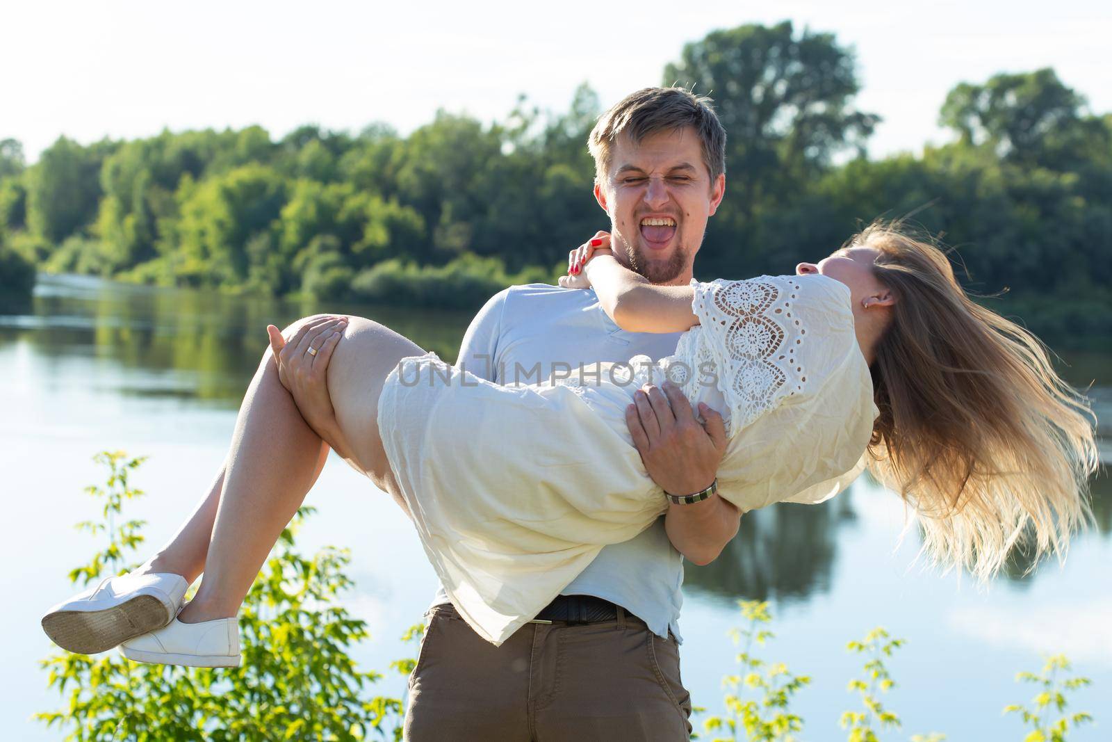 Young couple in love outdoor.Stunning sensual outdoor portrait of young stylish fashion couple posing in summer by Satura86