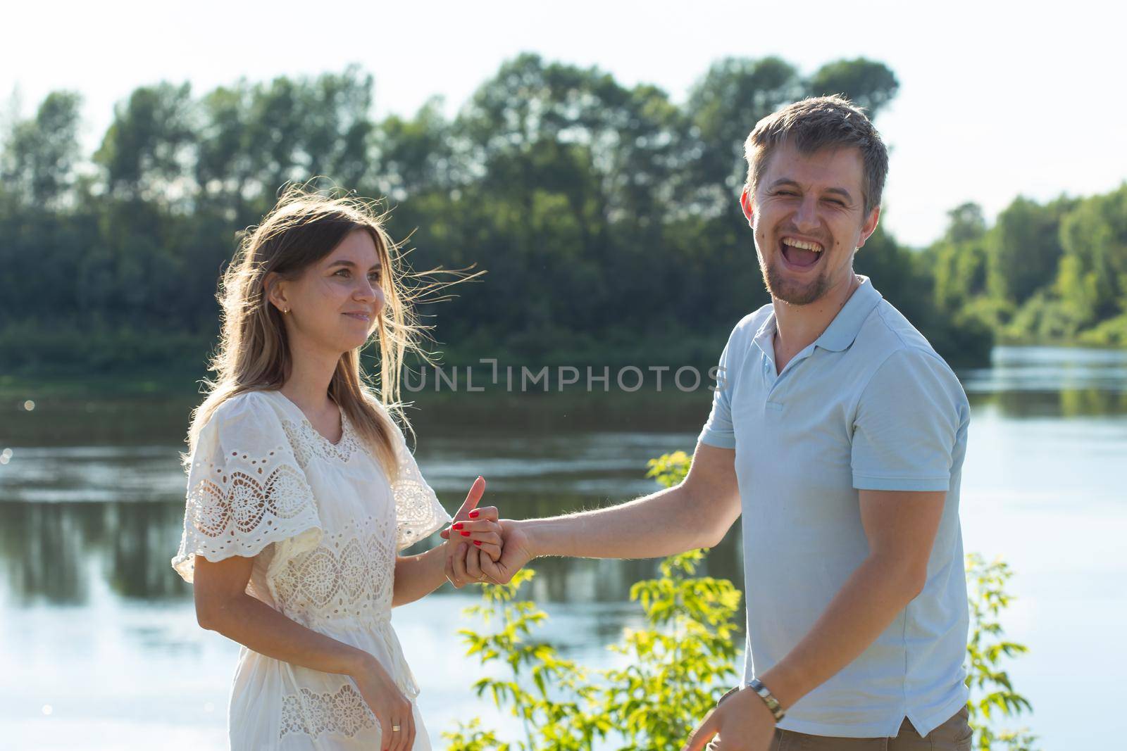 Young couple in love outdoor.Stunning sensual outdoor portrait of young stylish fashion couple posing in summer by Satura86
