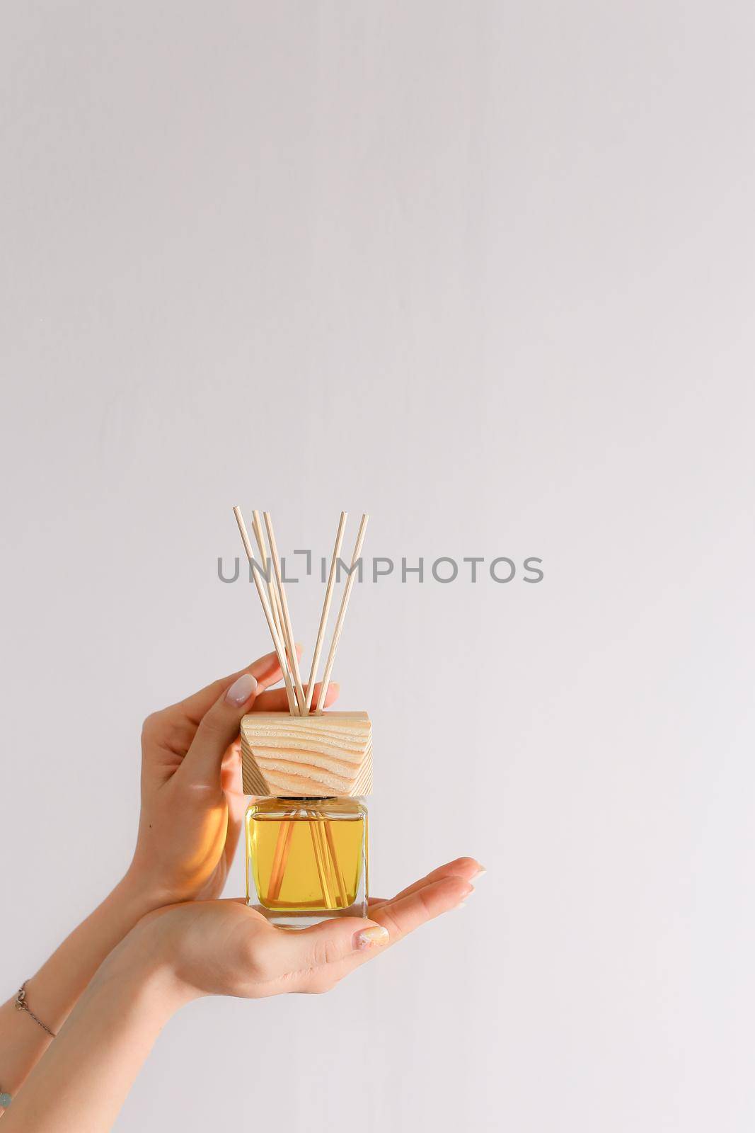 Aromatherapy reed diffuser air freshener on relaxed background with wooden sticks