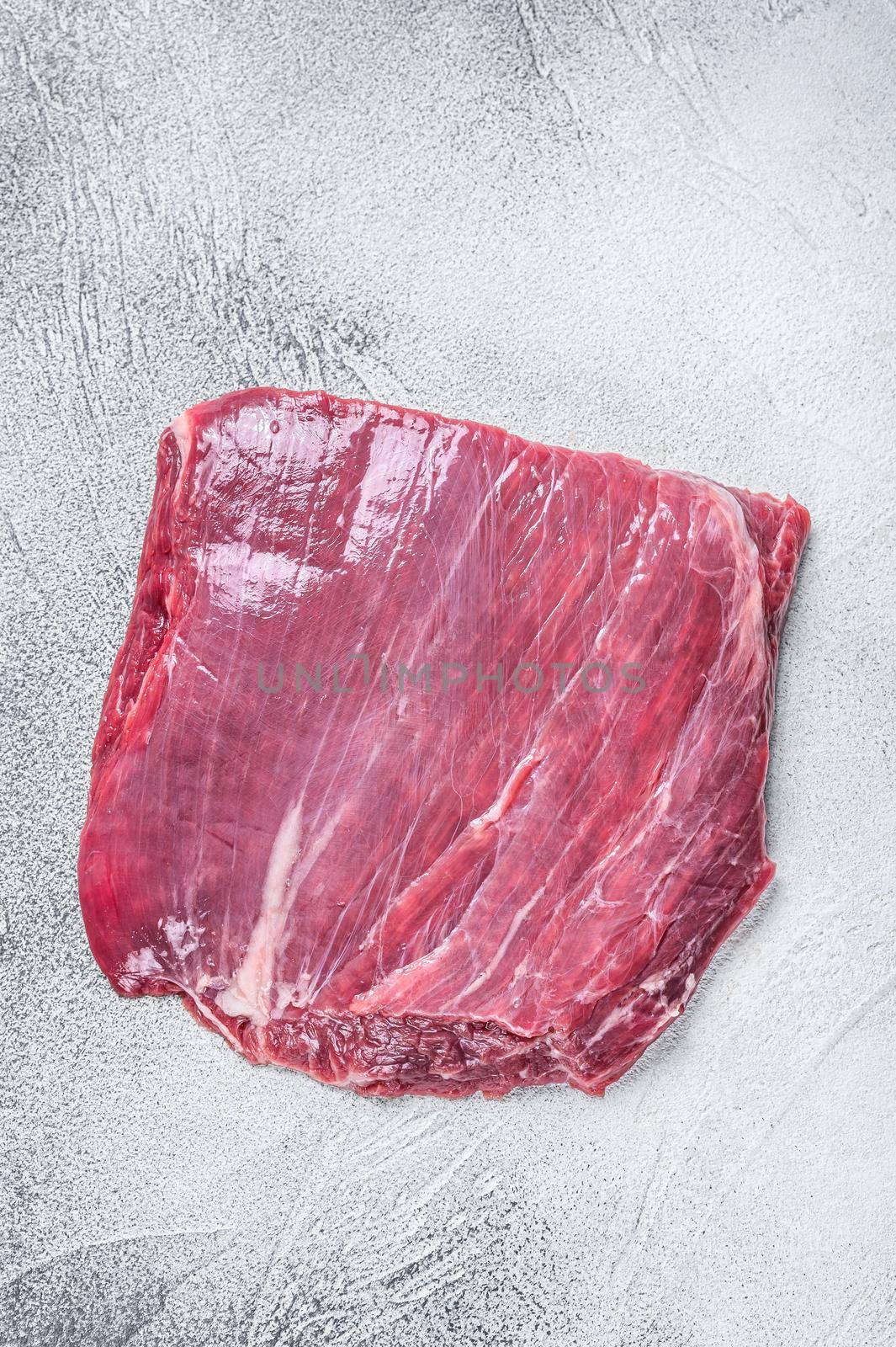 Raw flank or flap beef meat steak. White background. Top view.