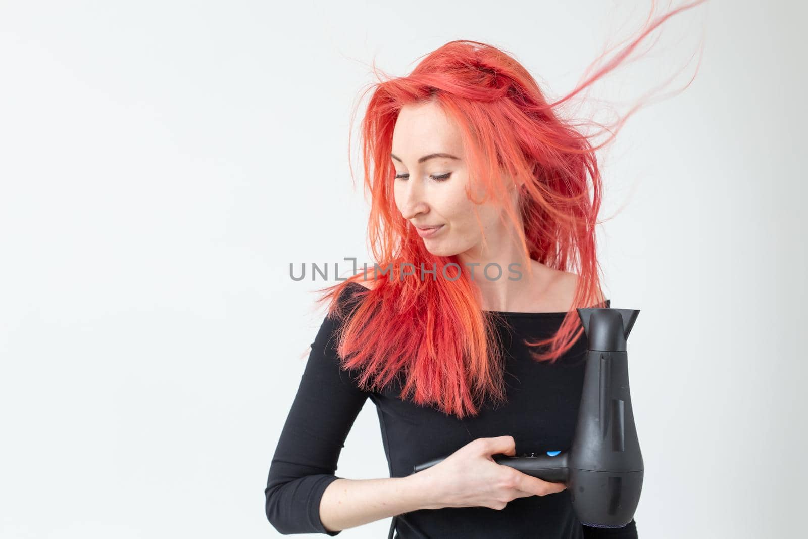 Stylist, hairdresser and people concept - Professional hairdresser with hair dryer on white background.