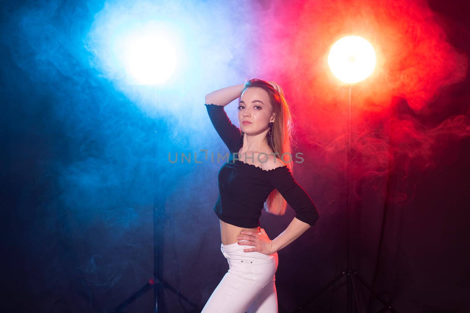 Young woman dancing in the dark, emotions and enjoyment.