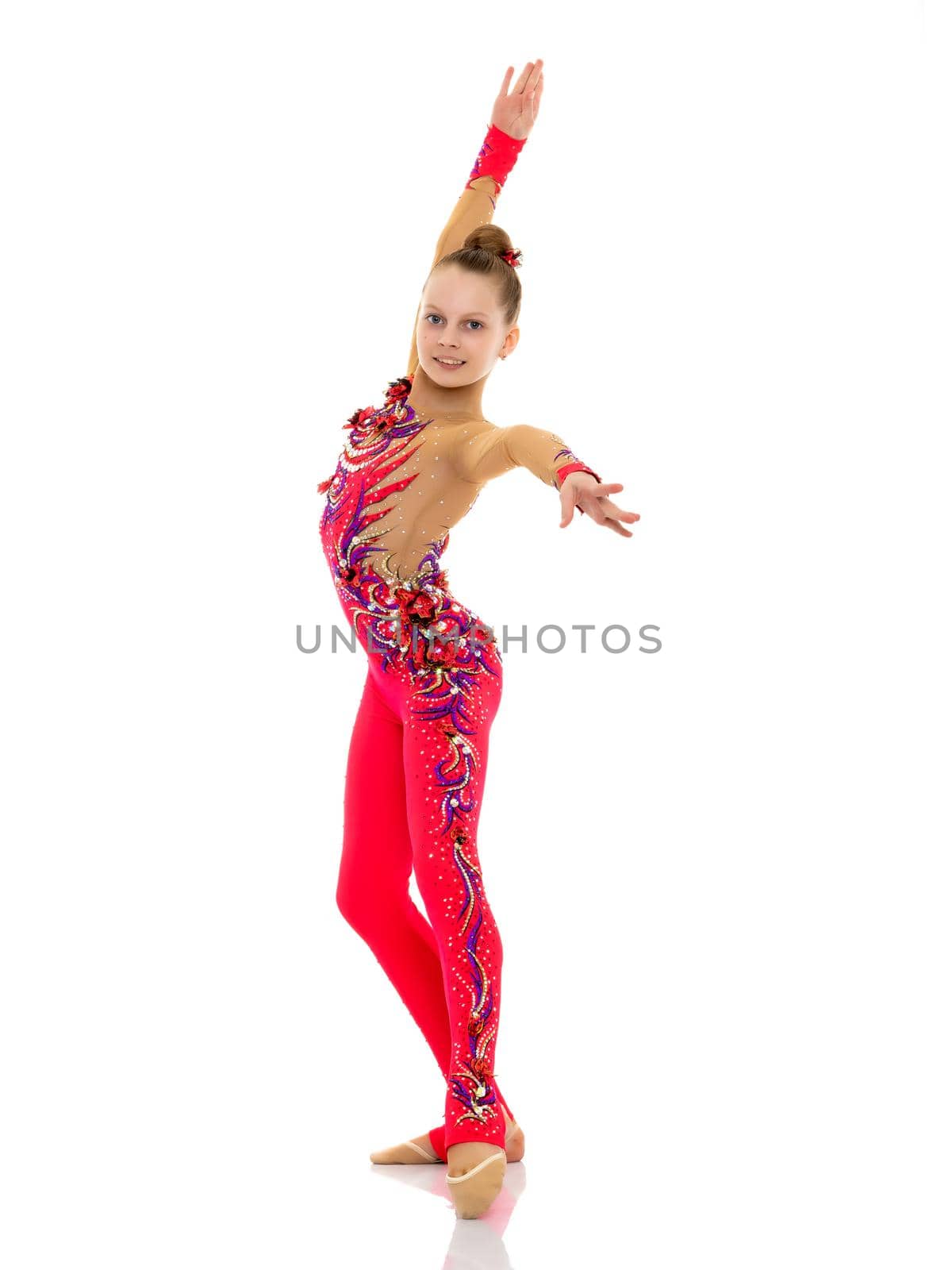 A gymnast girl prepares for the exercise. The concept of childhood and sport, a healthy lifestyle. Isolated on white background.