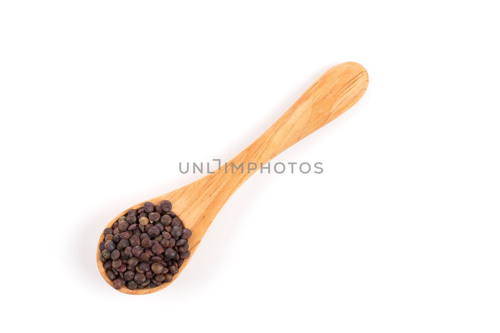 Brown organic lentils in wooden spoon isolated on white background