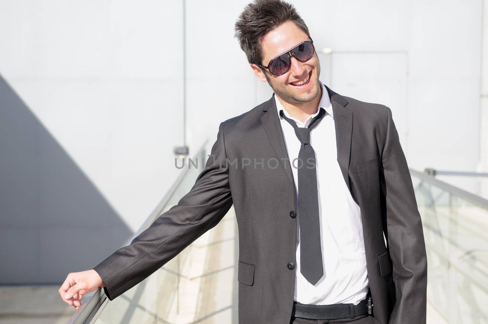 Portrait of a handsome young businessman laughing