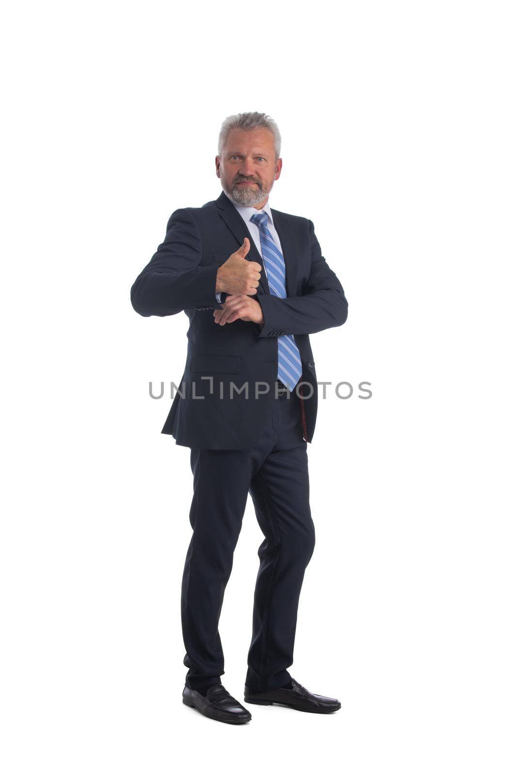 Full length portrait of smiling senior business man giving thumb up and holding a hand into suit pocket isolated on white background