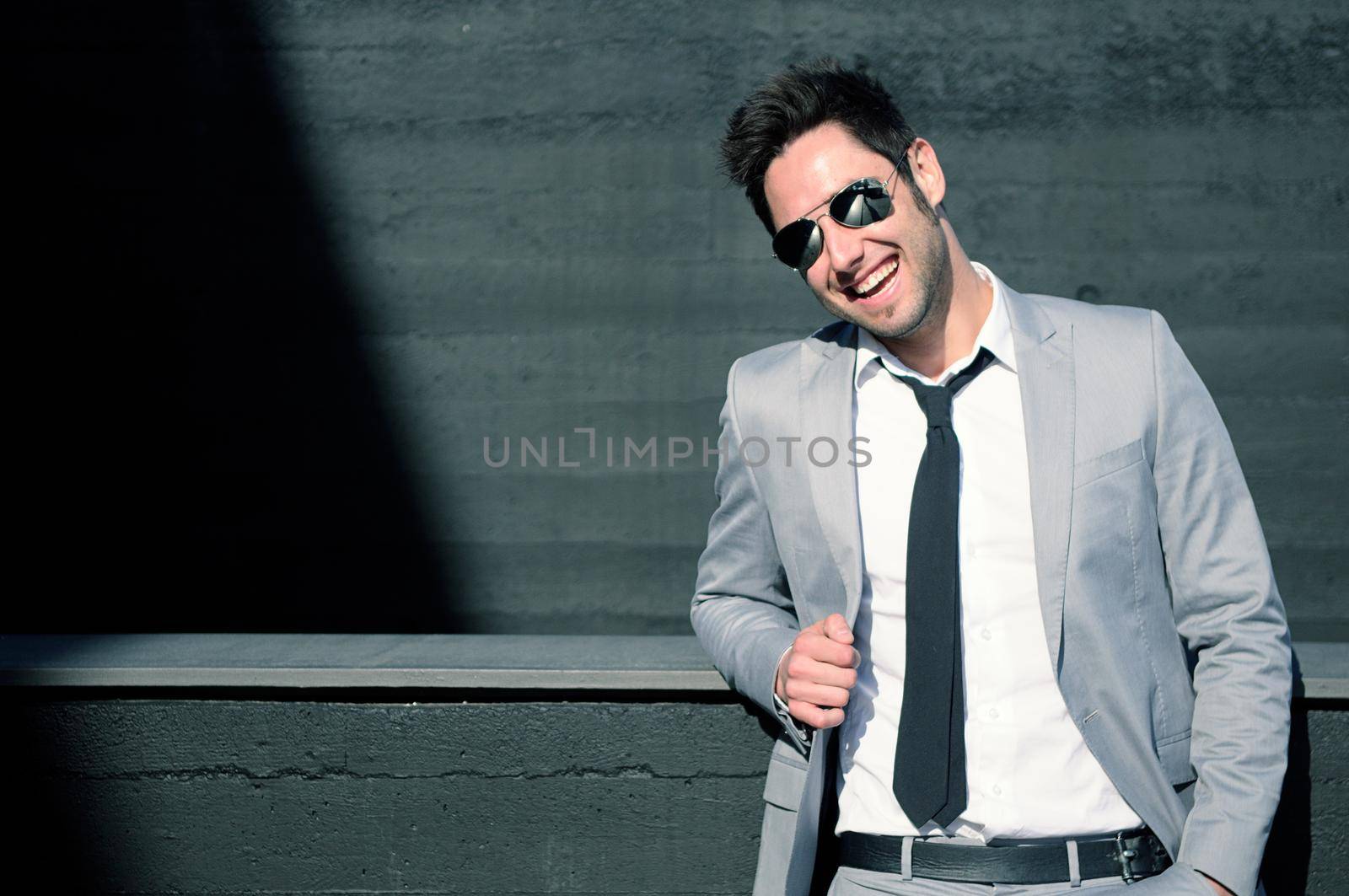 Portrait of a handsome young businessman laughing