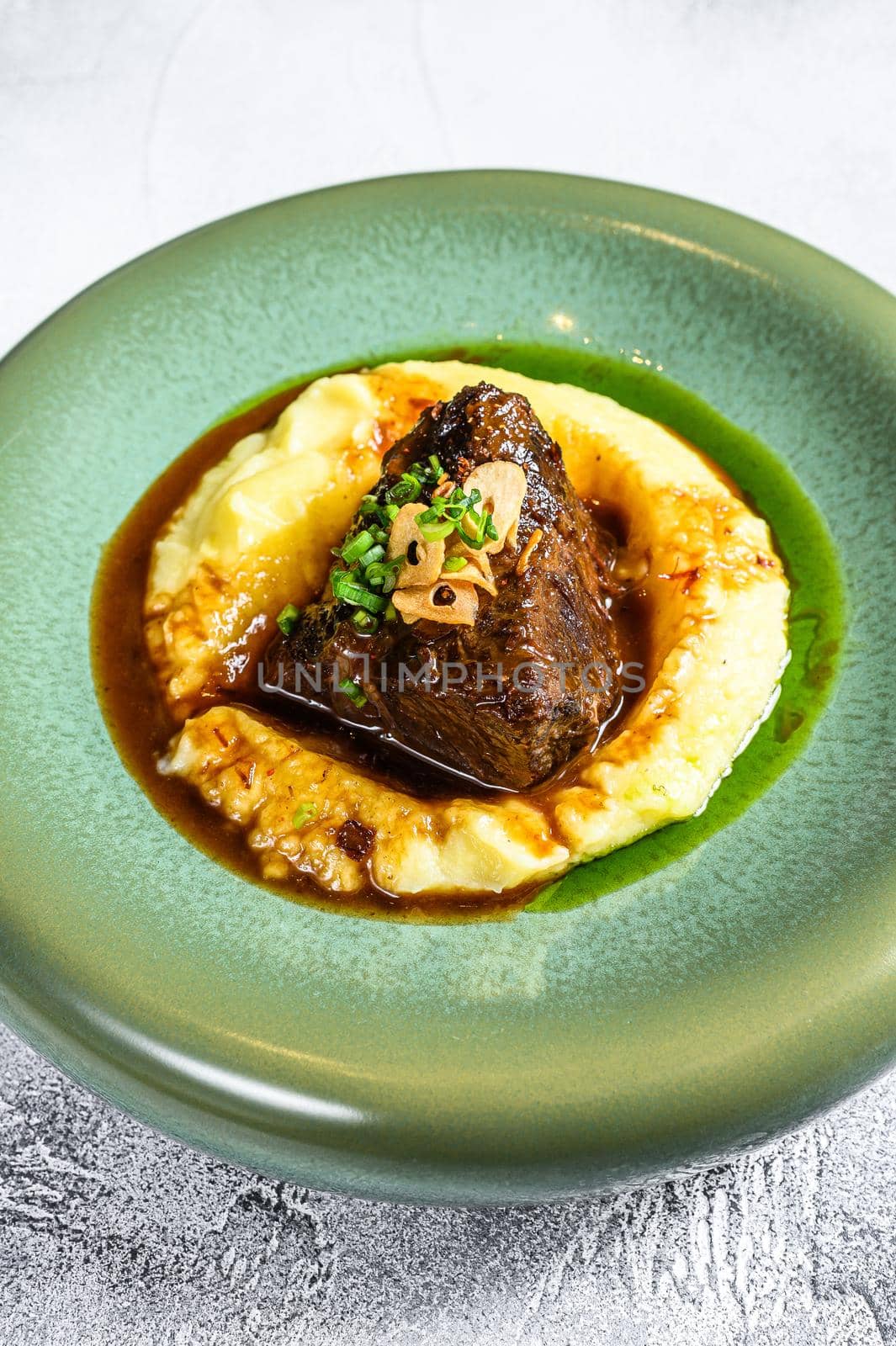 Beef sirloin fillet steak with a side dish of mashed potatoes. Gray background. Top view. Copy space.
