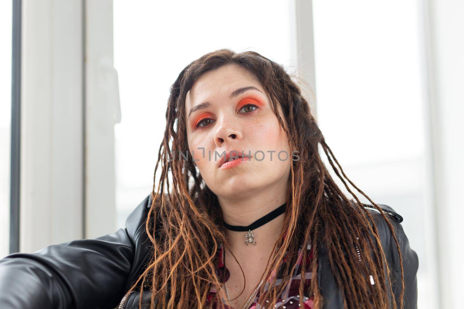 Dreadlocks, hairdresser and style concept - A stylish girl with dreadlocks and in leather jacket and fashionable makeup by Satura86