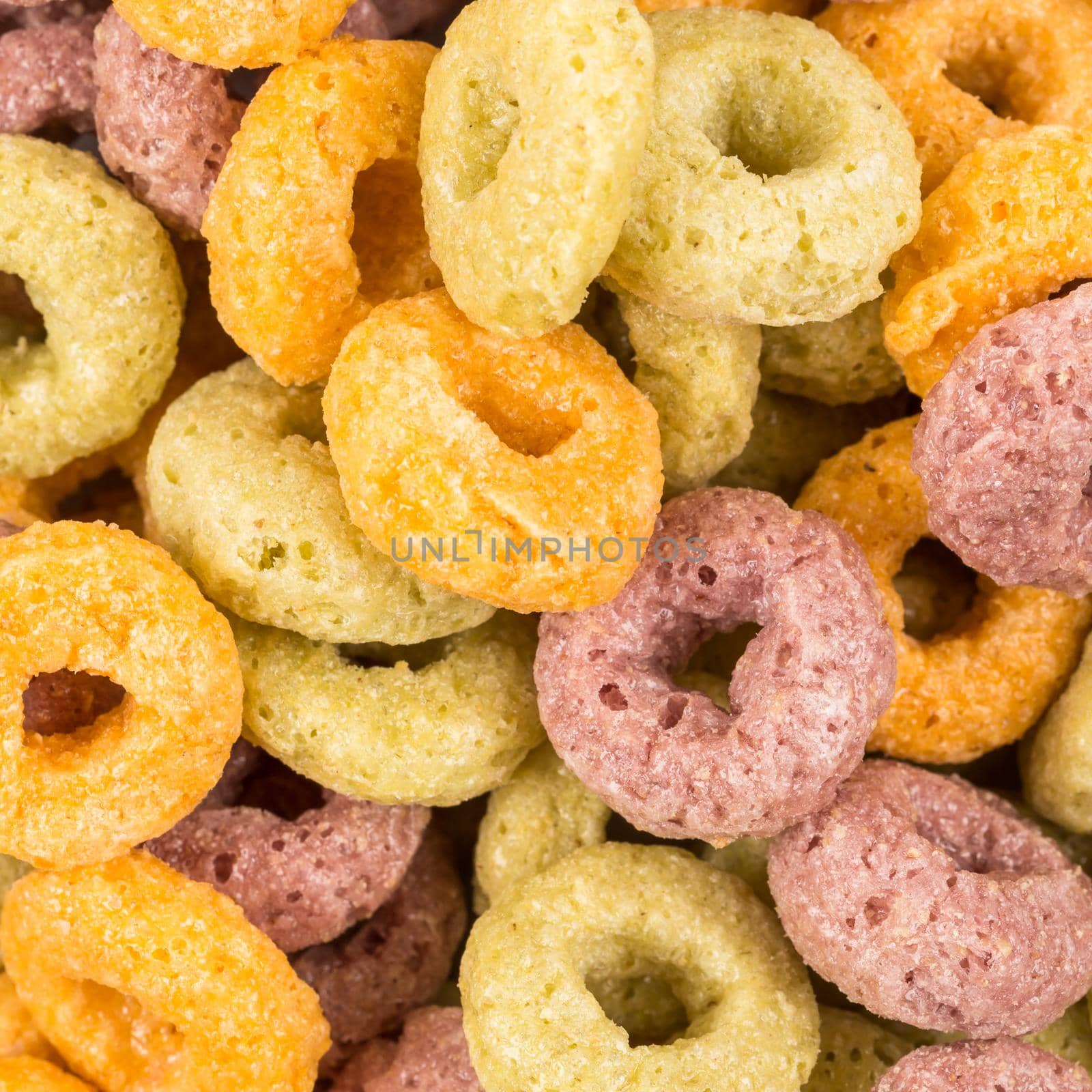 Close up image of colorful cereal against white background