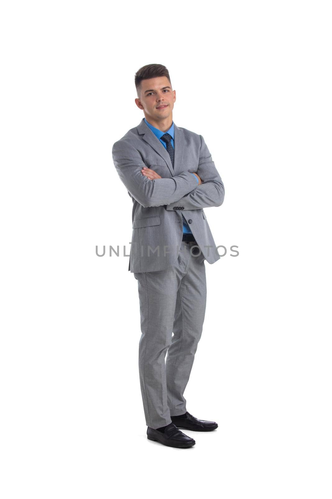 Full length of a young business man with crossed arms isolated on white background