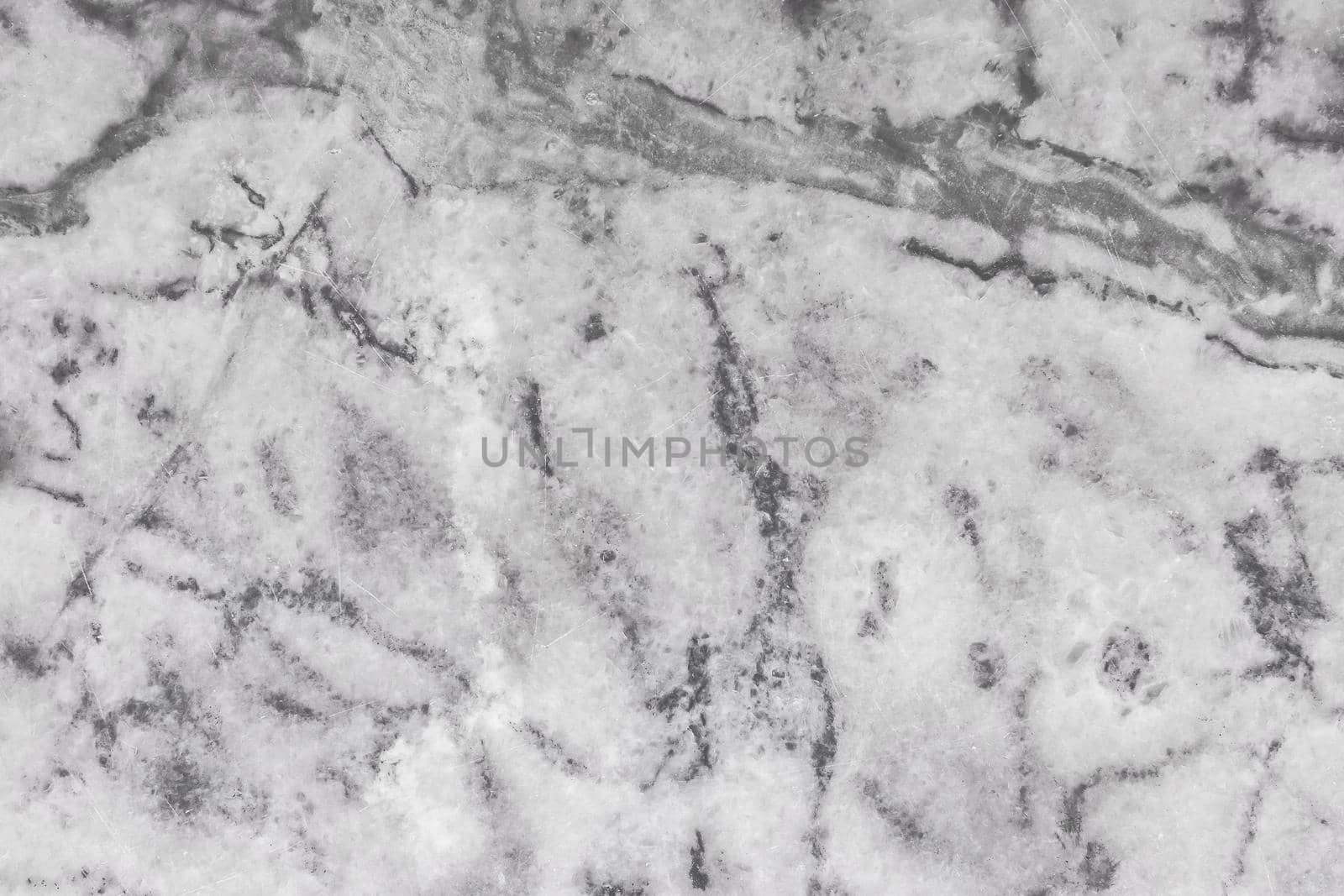 Gray stone granite or old marble slab surface with abstract dark pattern texture background.