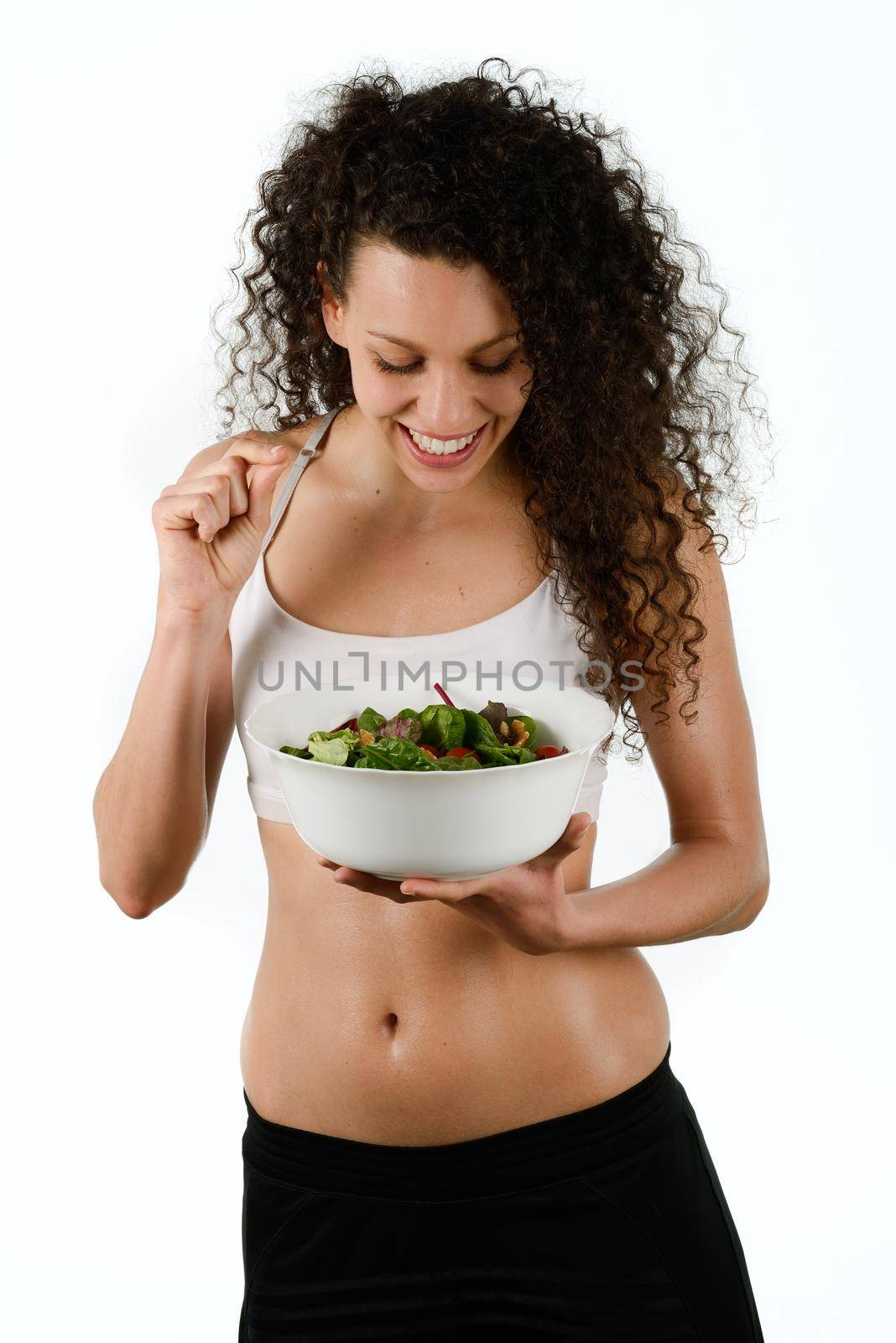 Portrait of beautiful young mixed woman with salad, isolated on white