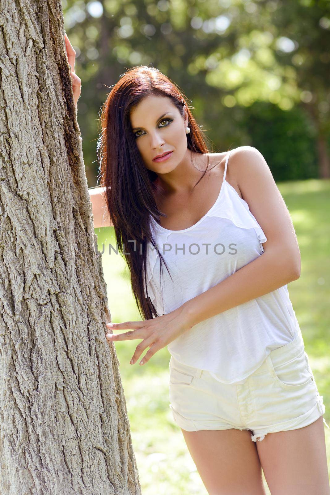 Portrait of a beautiful girl with green eyes in the park