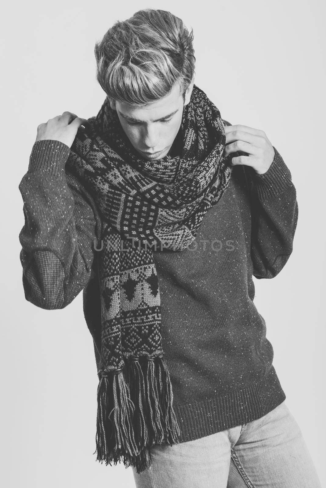 Portrait of handsome blonde man wearing sweater and scarf