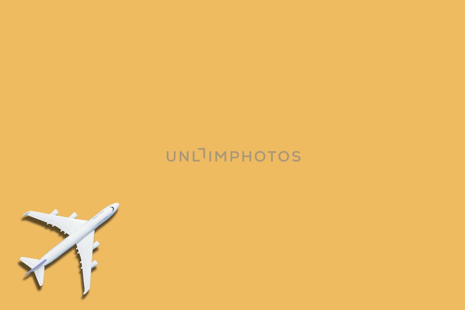 Miniature toy airplane on yellow background. Trip by airplane. 3d rendering by Andelov13