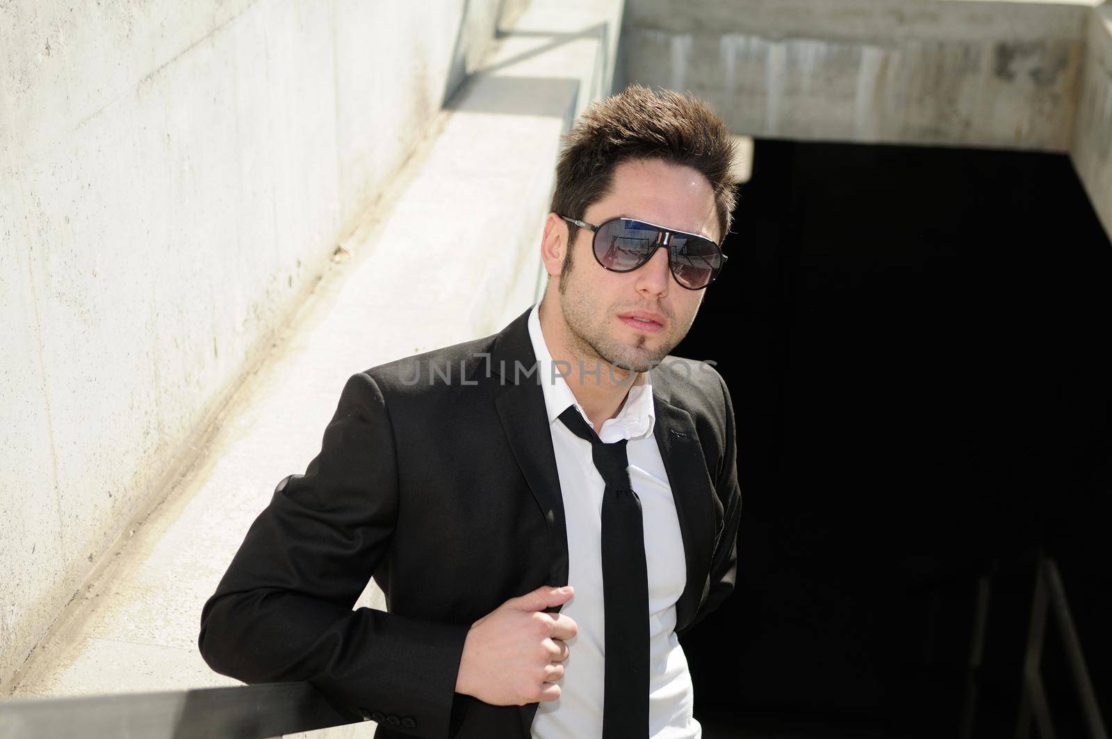 Portrait of a handsome young businessman with sunglasses