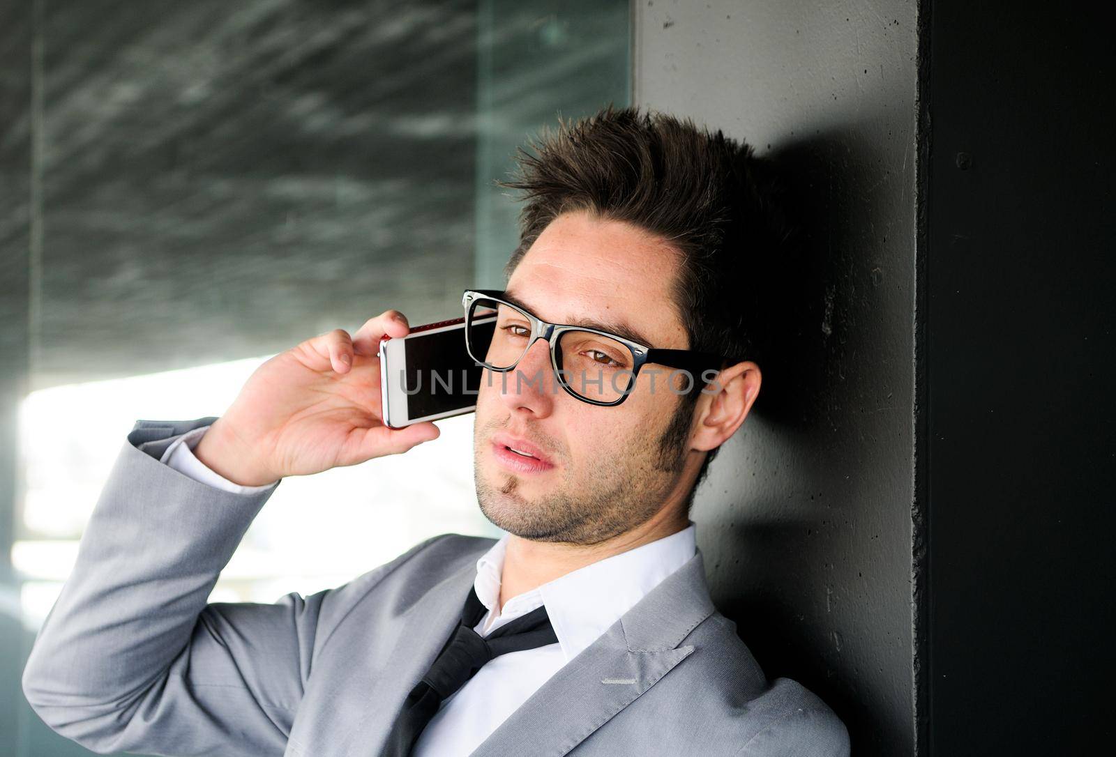 Portrait of a handsome young business man talking on mobile phone