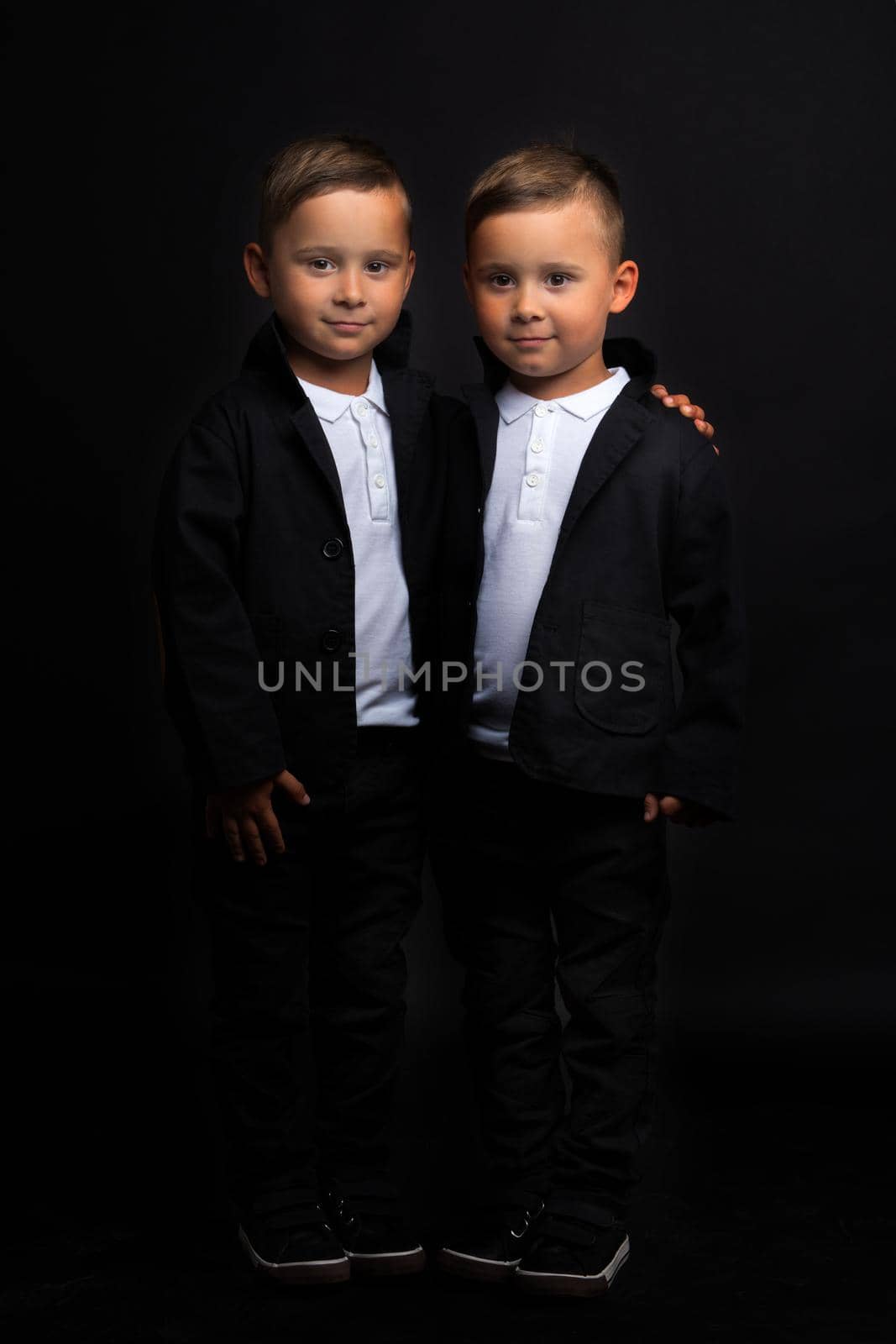 Two beautiful boys in black suits by kolesnikov_studio