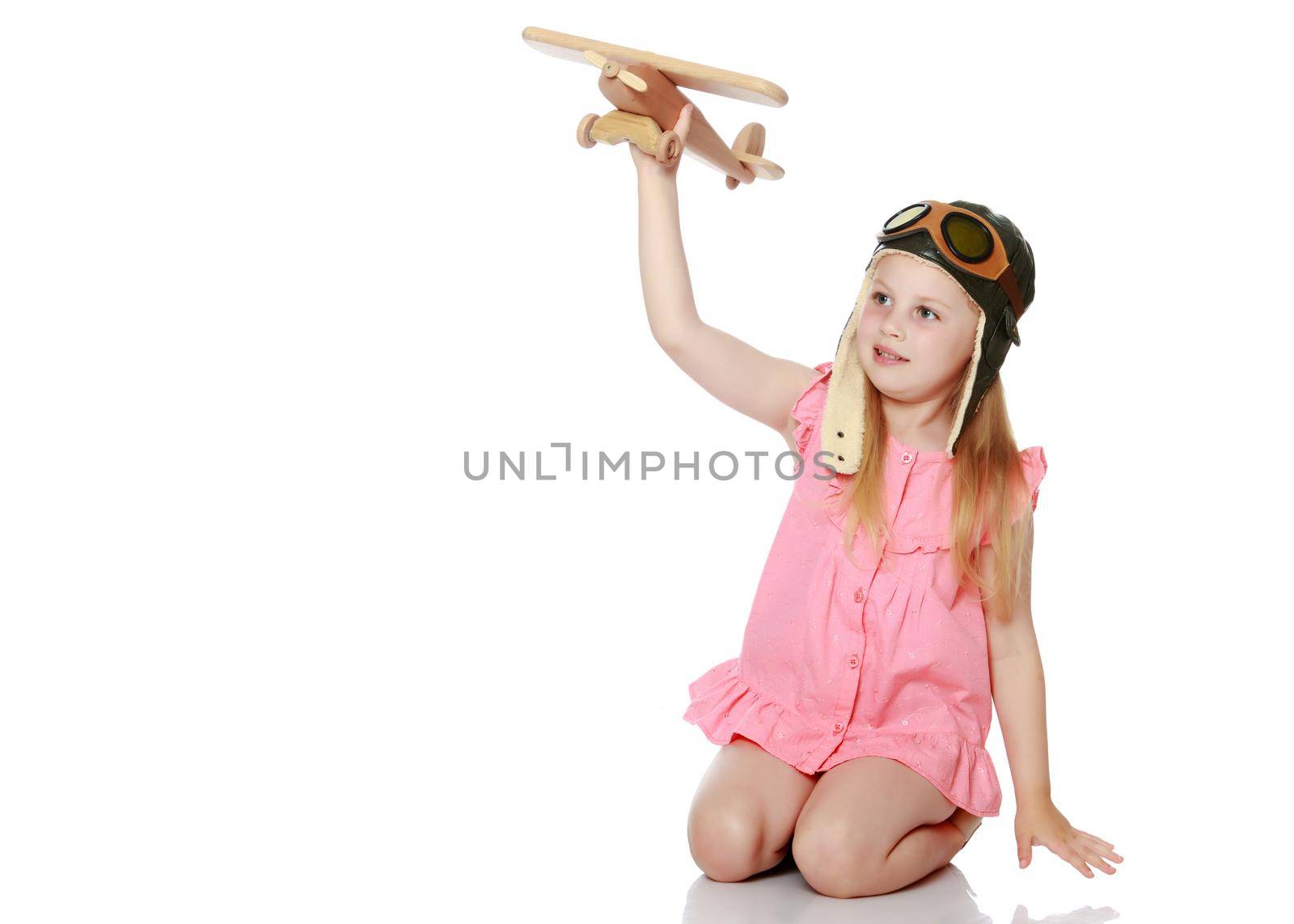 Little girl with a plane in her hand. by kolesnikov_studio