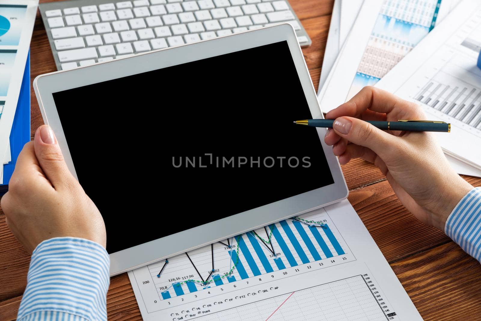 close-up, female hands with tablet. Business woman working at the table in the office