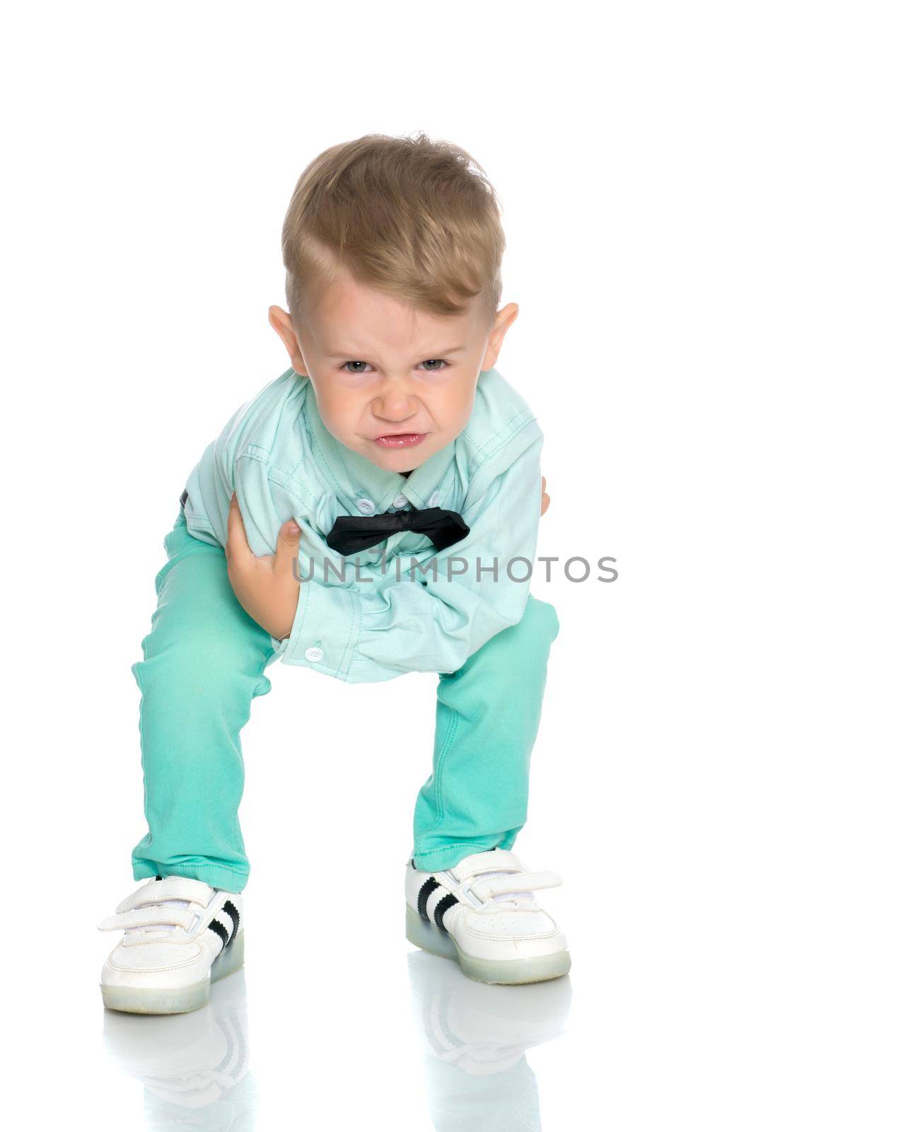 Little boy emotionally waving his hands in the studio on a white background. The concept of a happy childhood, family and people. Isolated.