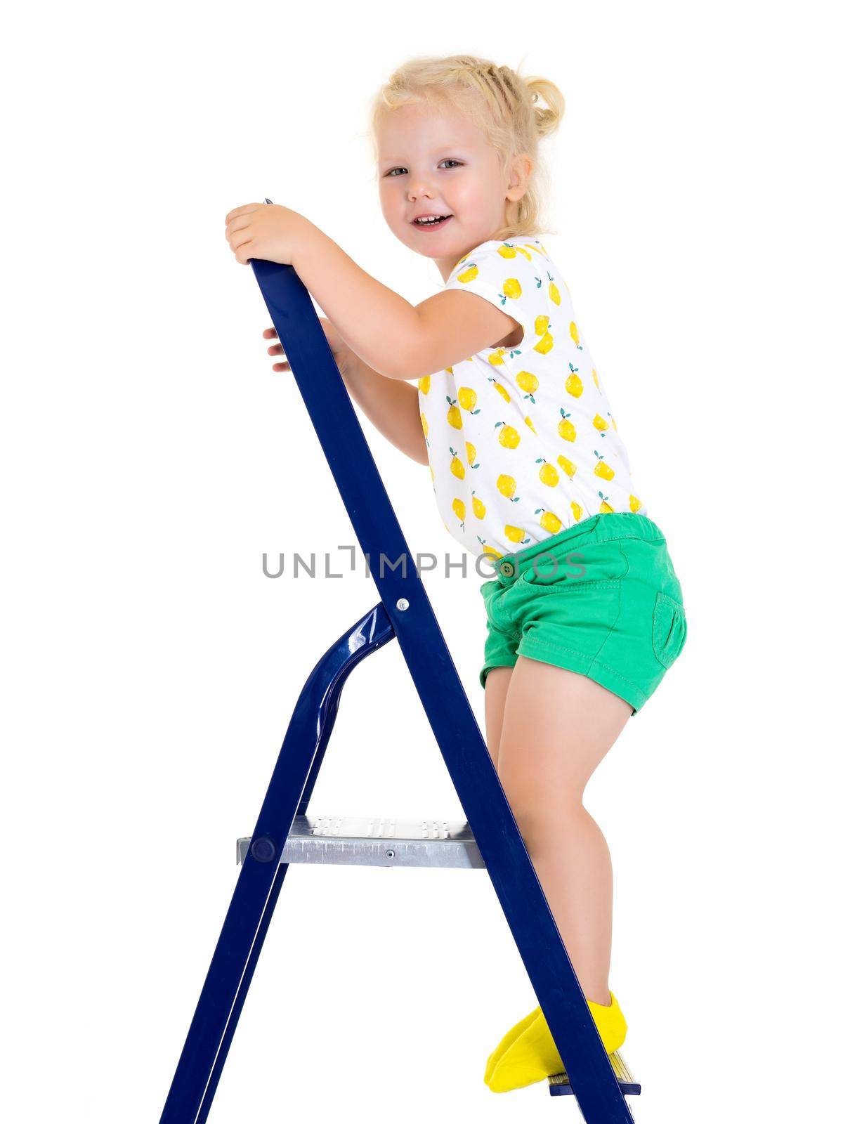 A little girl climbs the ladder. Concept of repair and construction, happy childhood. Isolated on white background.