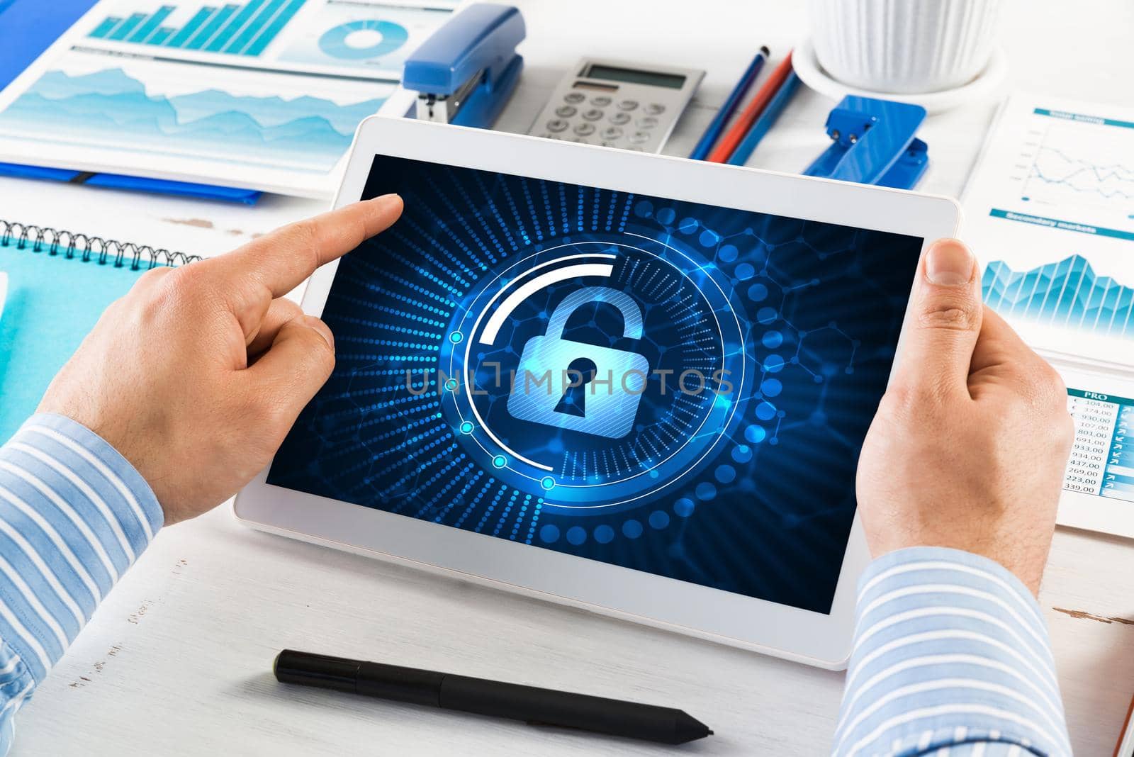 close-up, male hands with tablet. Businessman working at the table in office. computer security concept