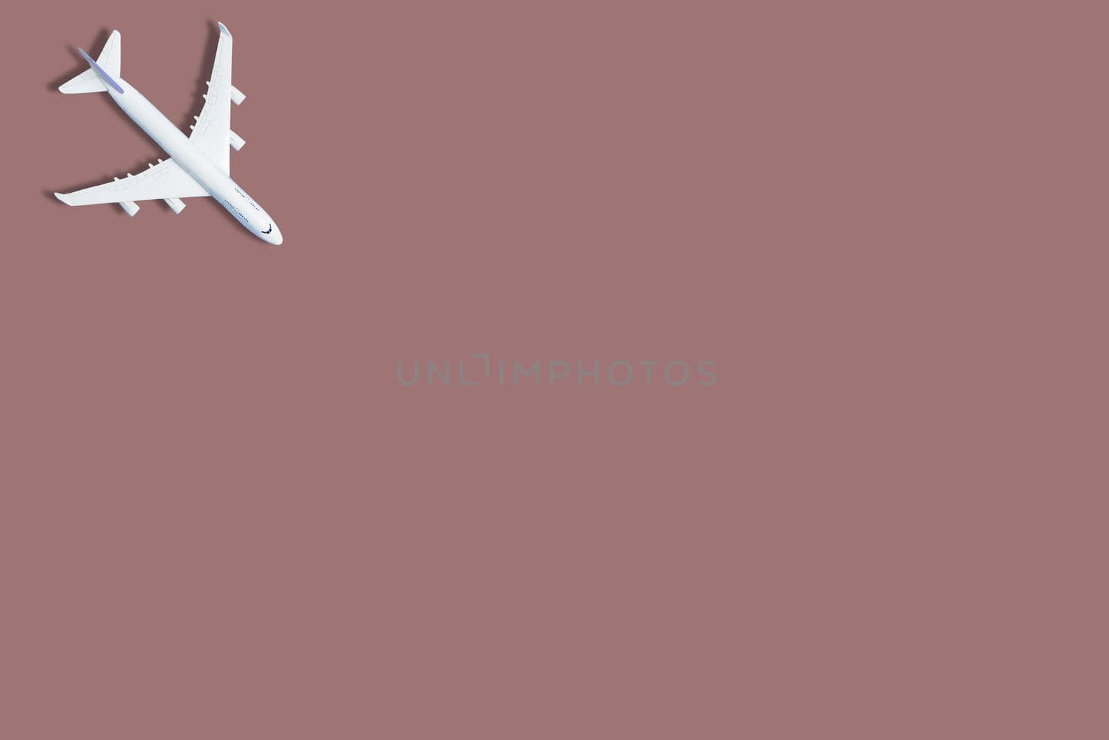 airplane figure on pink background