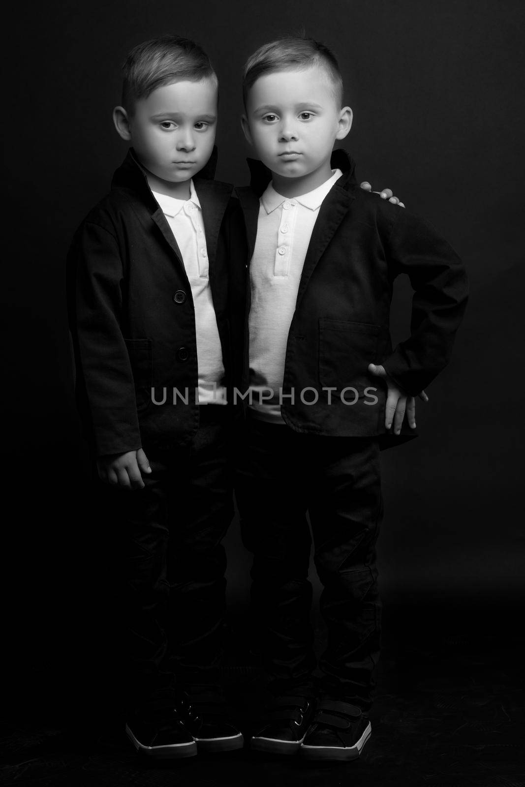 Two beautiful boys in black suits by kolesnikov_studio