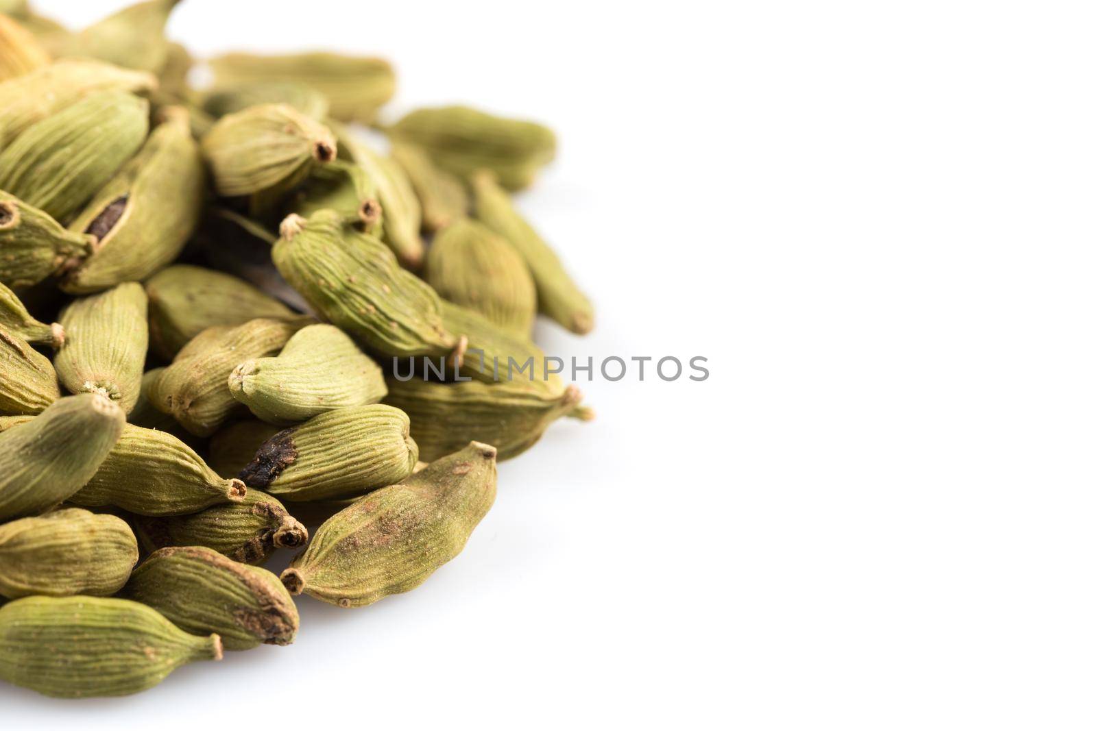 Heap of cardamom pods isolated on a white background