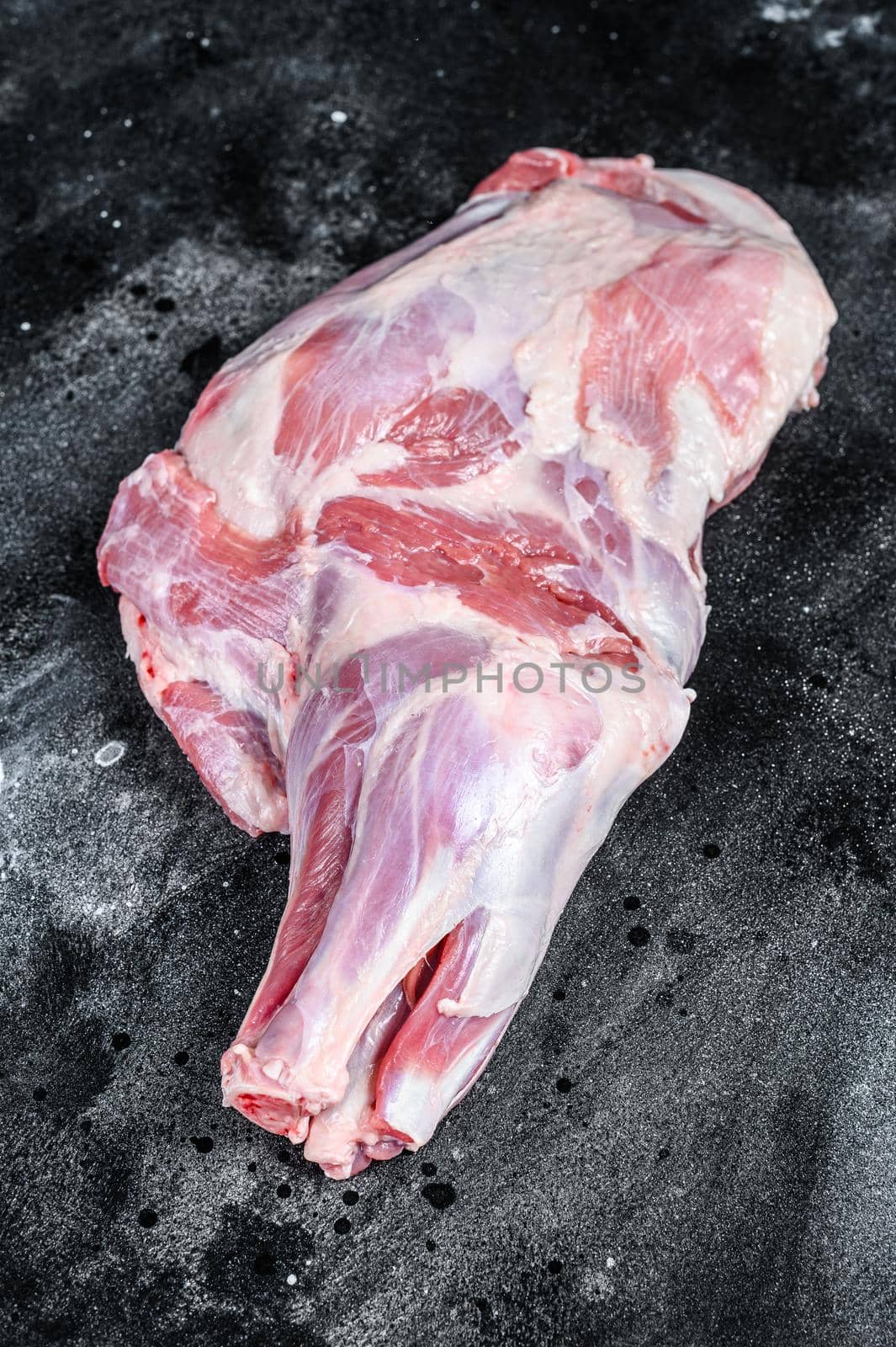 Raw lamb shoulder meat. Black background. Top view.