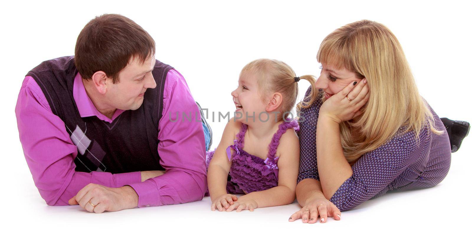 Happy family of three mom, dad and adorable little girl lying on the floor, and parents fondly looking on the beloved daughter-Isolated on white background