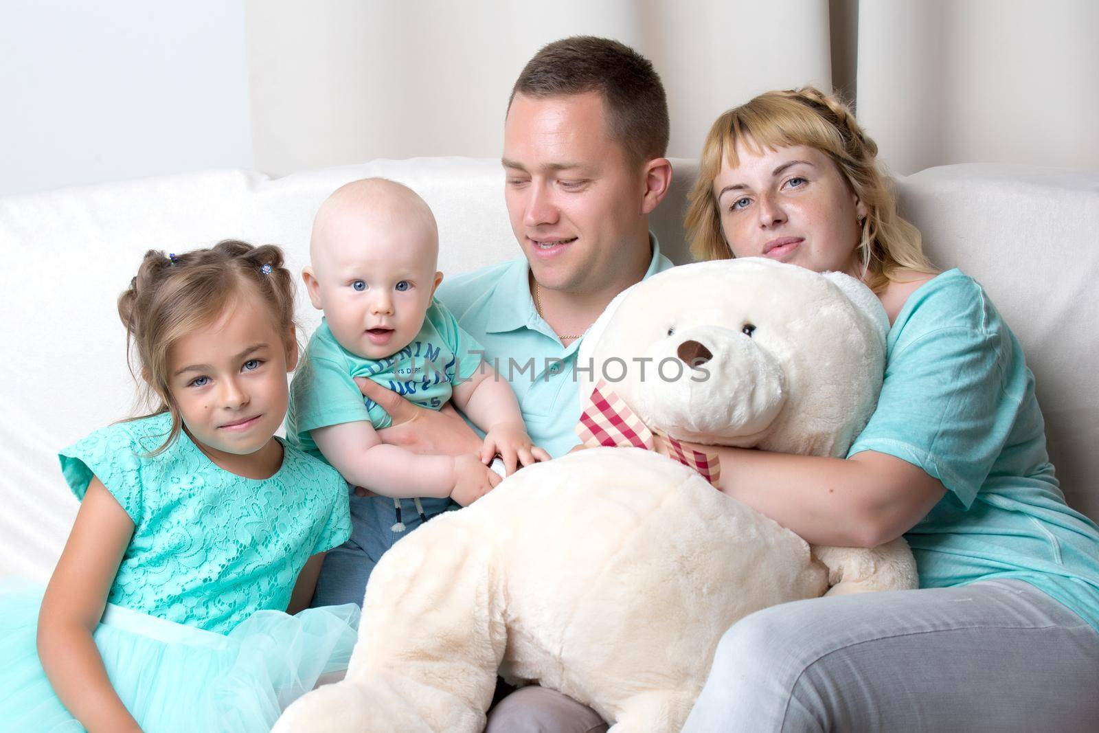 Happy family with young children by kolesnikov_studio