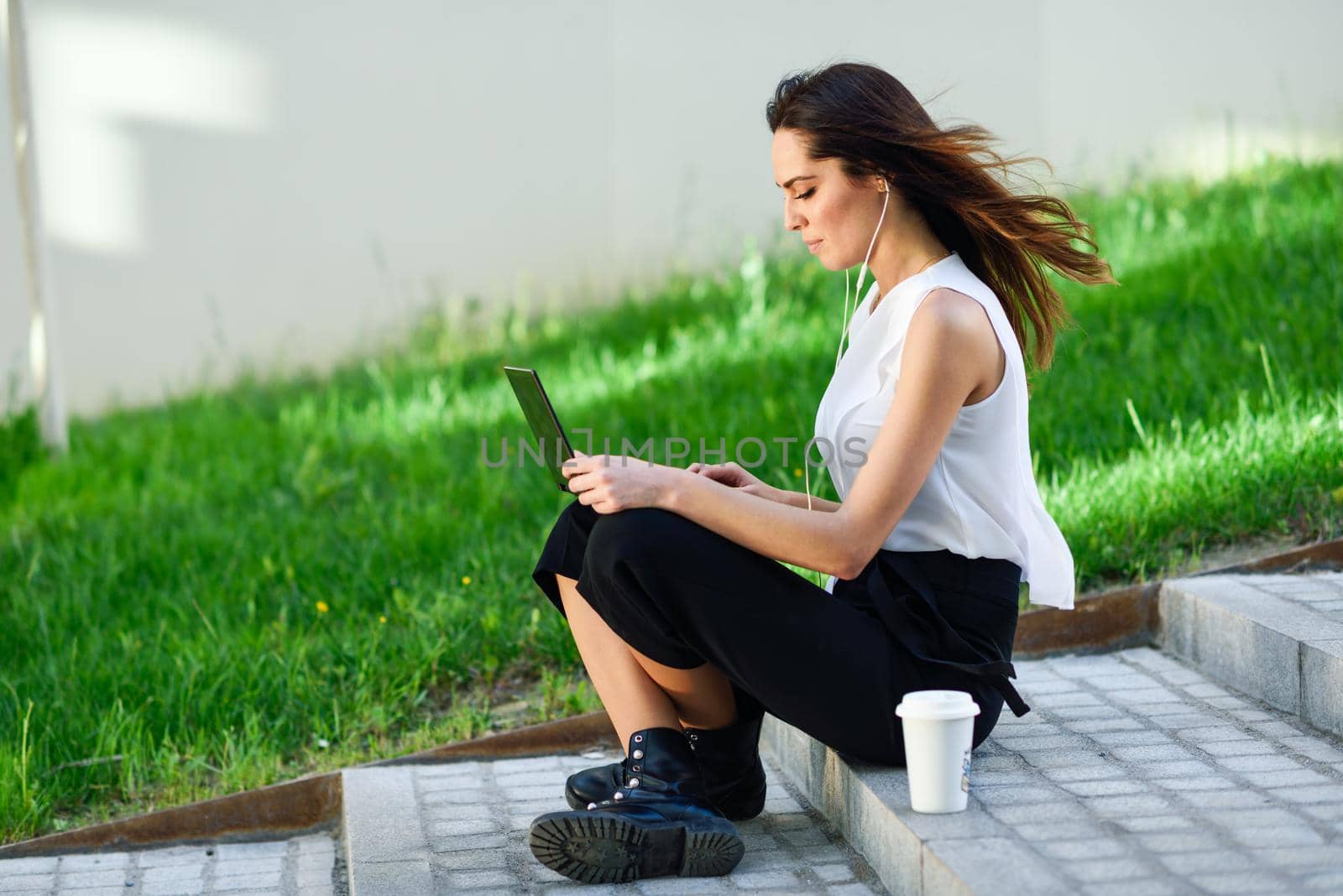 Middle-age businesswoman working with her laptop computer sitting on the floor. by javiindy