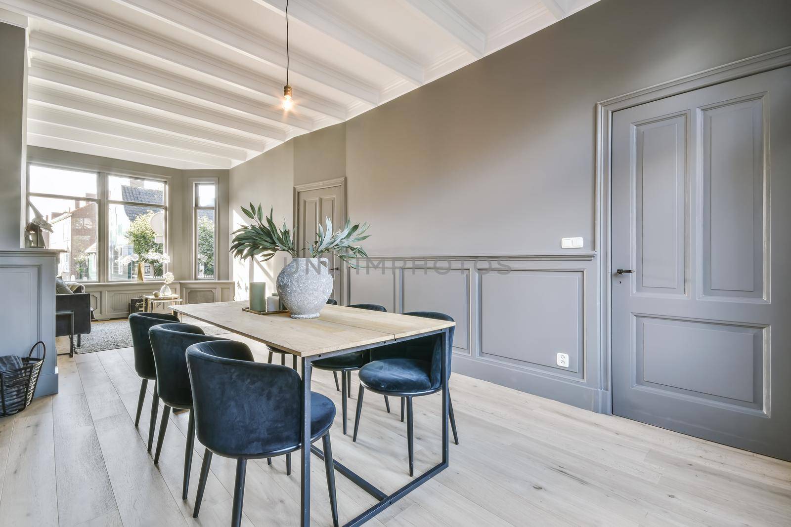 Bright dining room with blue velvet table and chairs