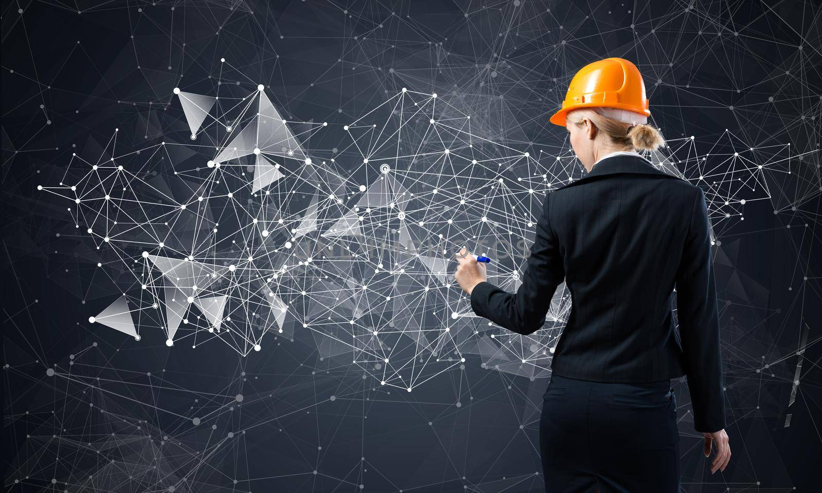 Businesswoman pointing on abstract 3d network. Back view of woman engineer in business suit and safety helmet. Social connection and networking. Futuristic technology concept with 3d plexus structure.