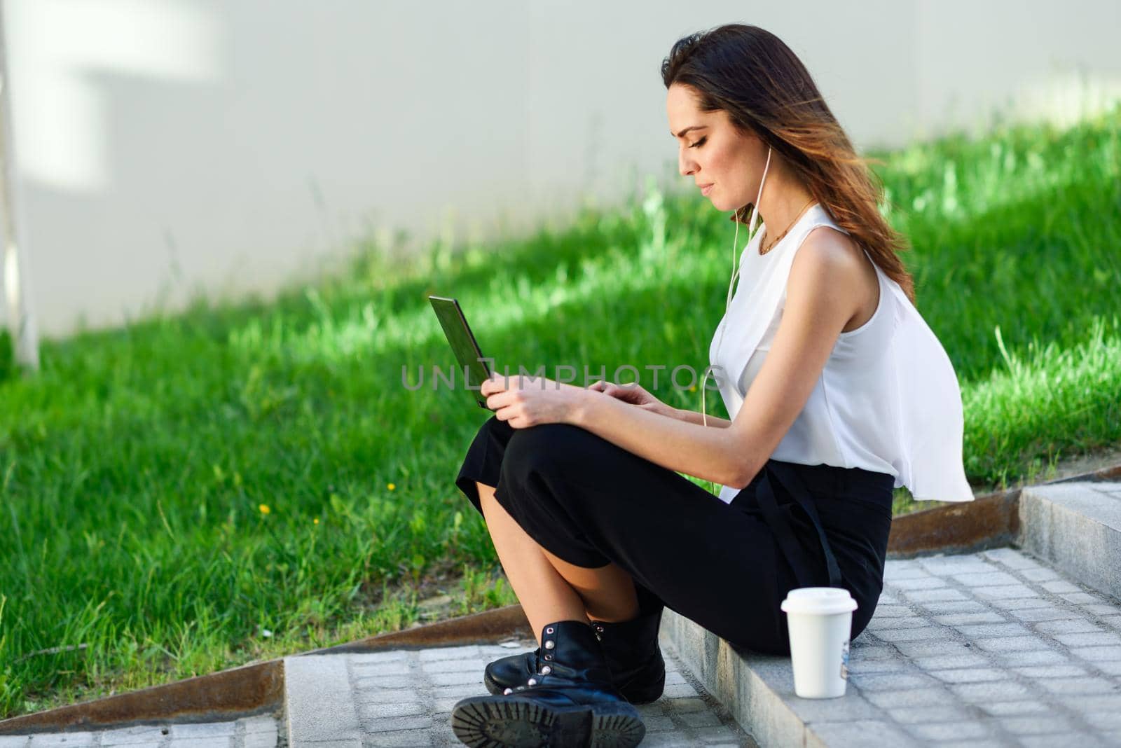 Middle-age businesswoman working with her laptop computer sitting on the floor. by javiindy