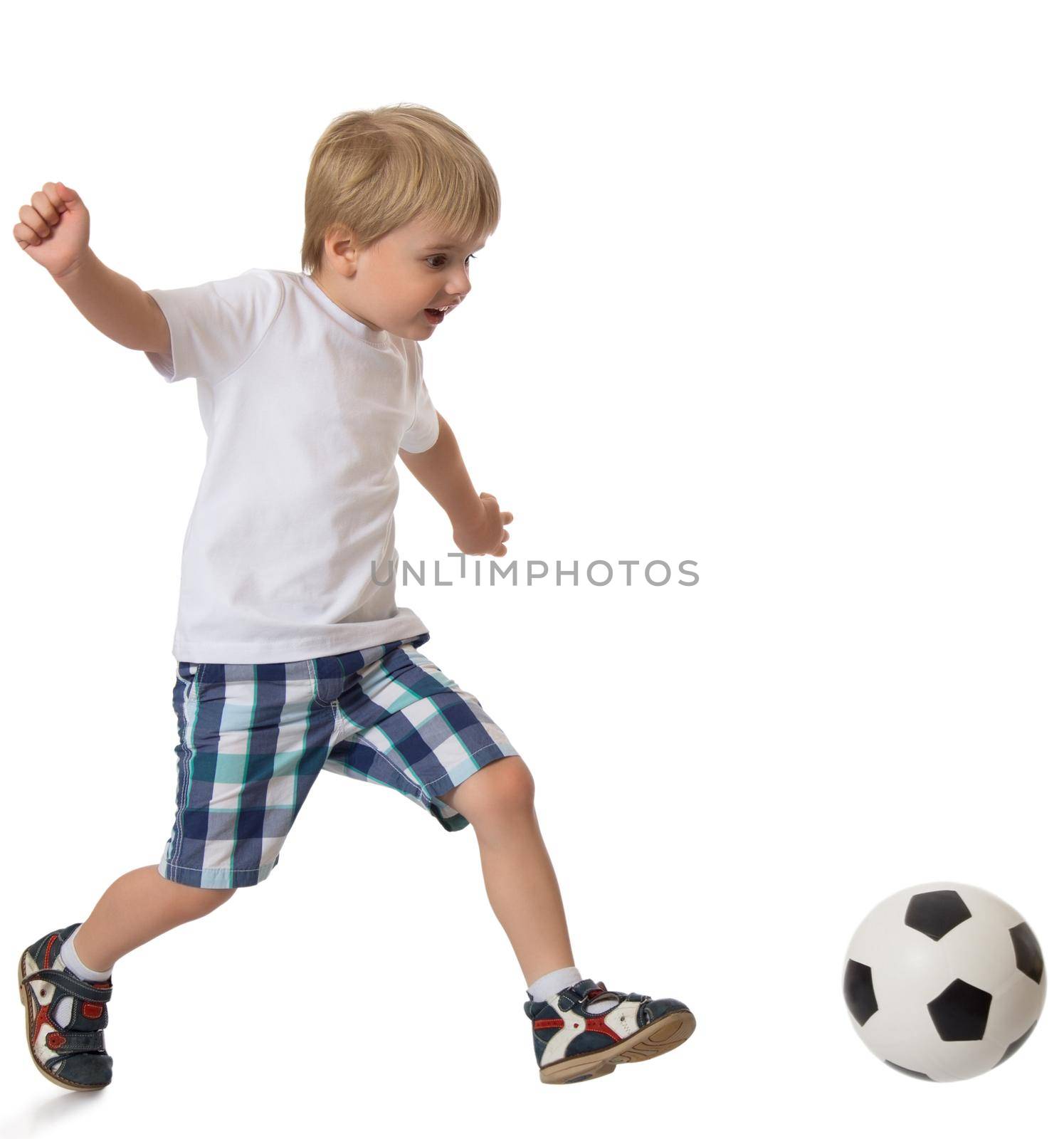 Little blond boy in a clean white t-shirt and shorts playing football - Isolated on white background