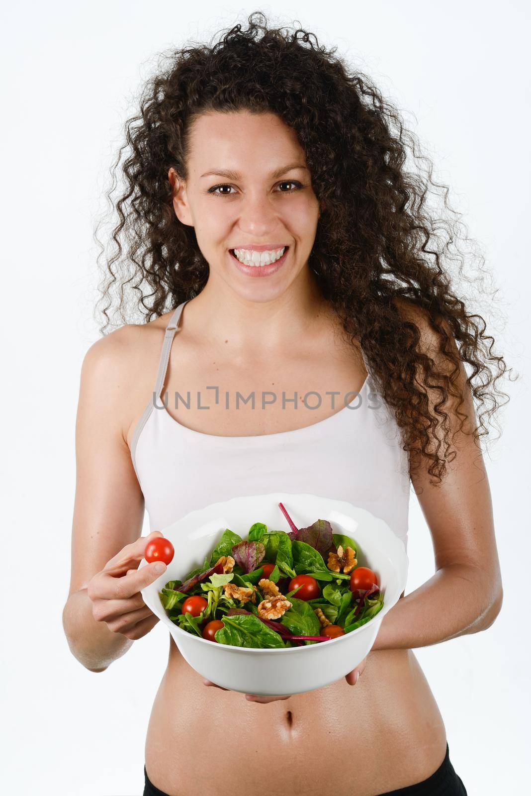 Portrait of beautiful young mixed woman with salad, isolated on white