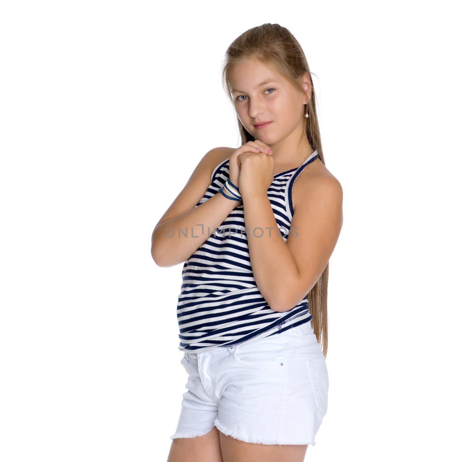 A beautiful teen girl sits on the floor on a white background. The concept of education and schoo. Isolated.