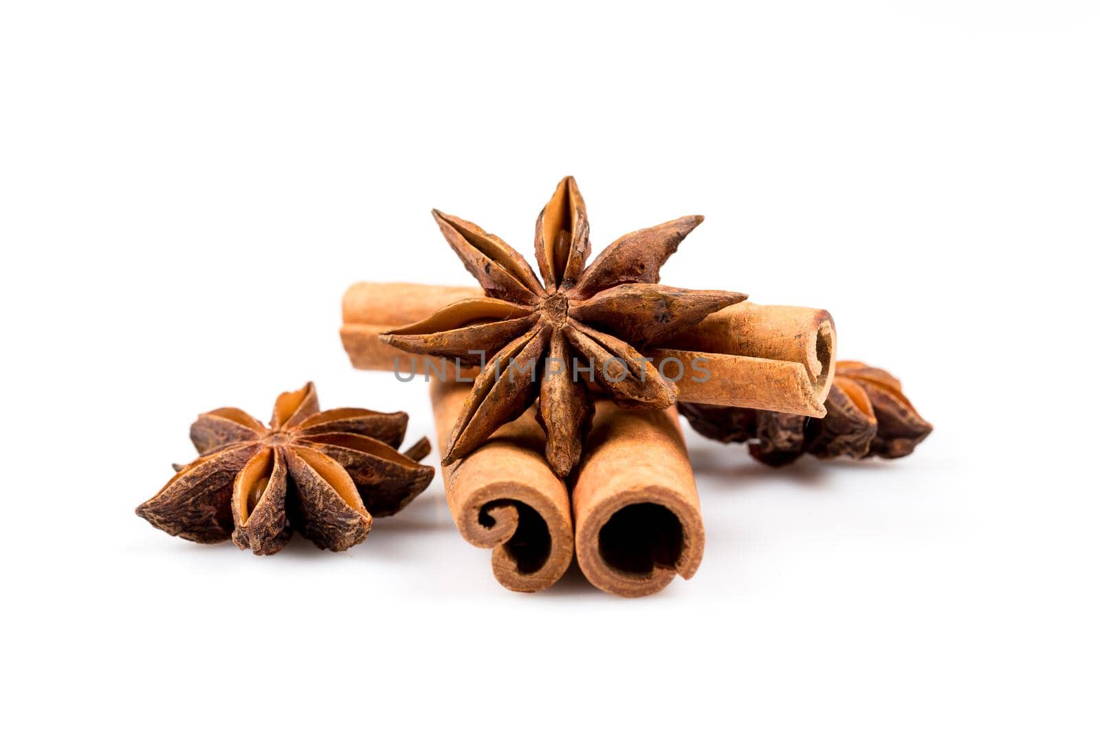 Stars of anise and cinnamon on white background