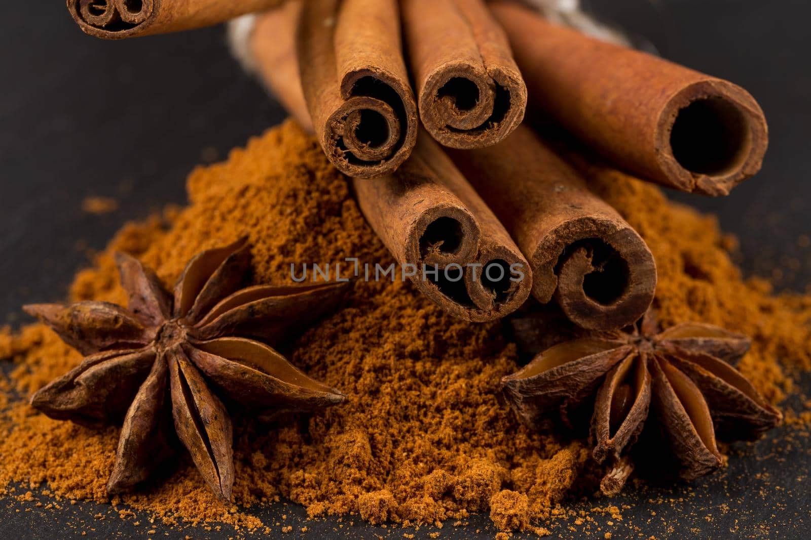 Anise and cinnamon close up on dark stone