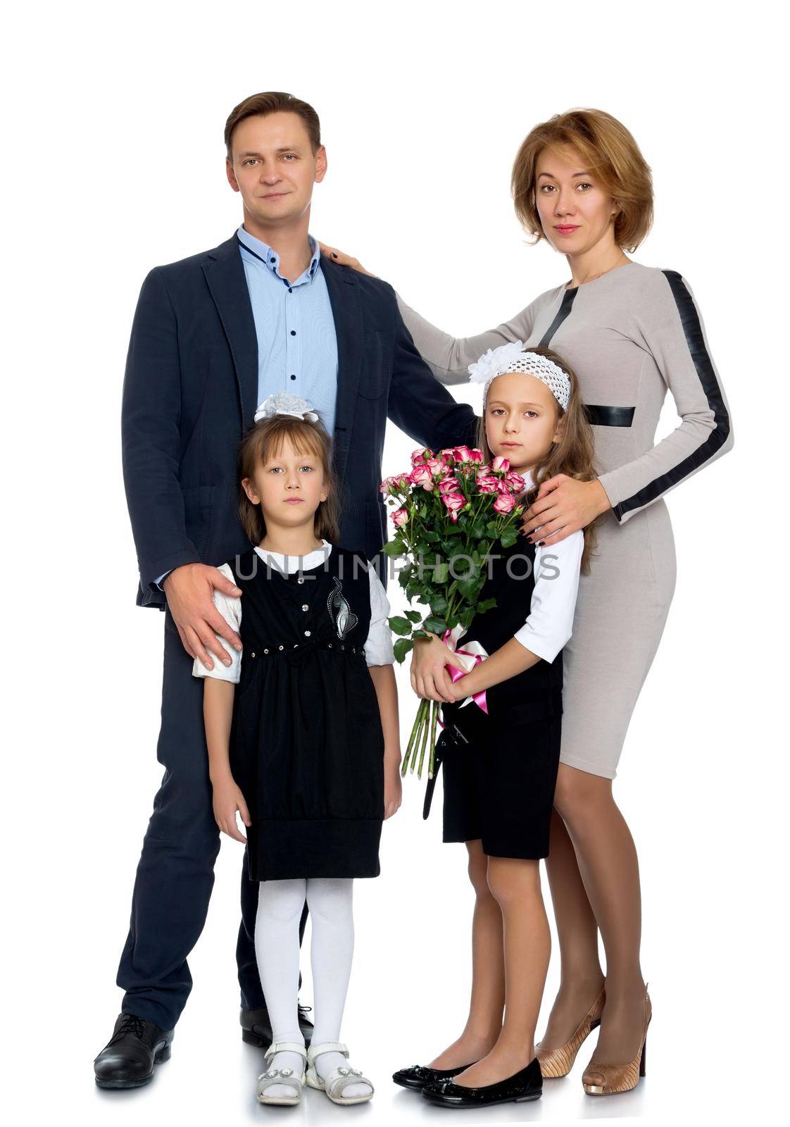 Family portrait of 4 people. Parents with two adorable school-age girls , with a bouquet of roses - Isolated on white background